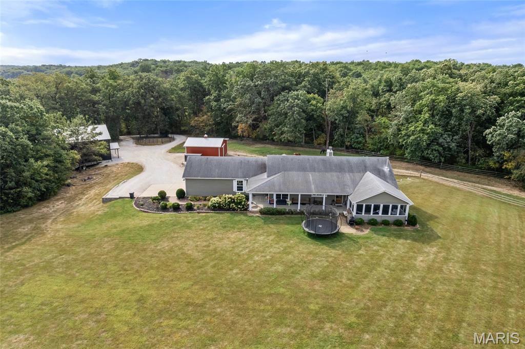 Immaculate 17+ Acre Horse Estate in Winfield! Pulling into your estate you will notice you gated and fenced entrance. Making your way up your tree lined driveway, you will see it open to your stunning property. Notice your spacious red barn with  horse stalls and beautiful pasture! you have an electric fence and ample room for riding in your fenced riding area. You will also see a nearly new 2500 Sq ft +/- pole barn measuring 48x48x16. The Barn offers concrete floors, a loft, and 100 Amp Service. Now your residence, walking up to your expansive porch you will notice the stunning French doors. Your residence features nearly 4000 sq ft of living space. Your entry opens up to a stunning great room with beautiful white oak hardwood floors, vaulted ceiling, and wood burning stove. Your kitchen is truly an entertainer or chefs delight with  custom cabinets, center island and walk in pantry! Off the kitchen you will find a hearth room with fireplace and breakfast room as well. Your main floor features a spacious primary suite, office, and bonus room as well! Do not forget about your incredible screened in porch and main floor laundry. Your lower level is a true extension of your residence with 3 bedrooms, full bath, and workshop! Your home also features a newer HVAC System! Just minutes from Hwy 61 and 79, but definitely a slice of heaven on earth!