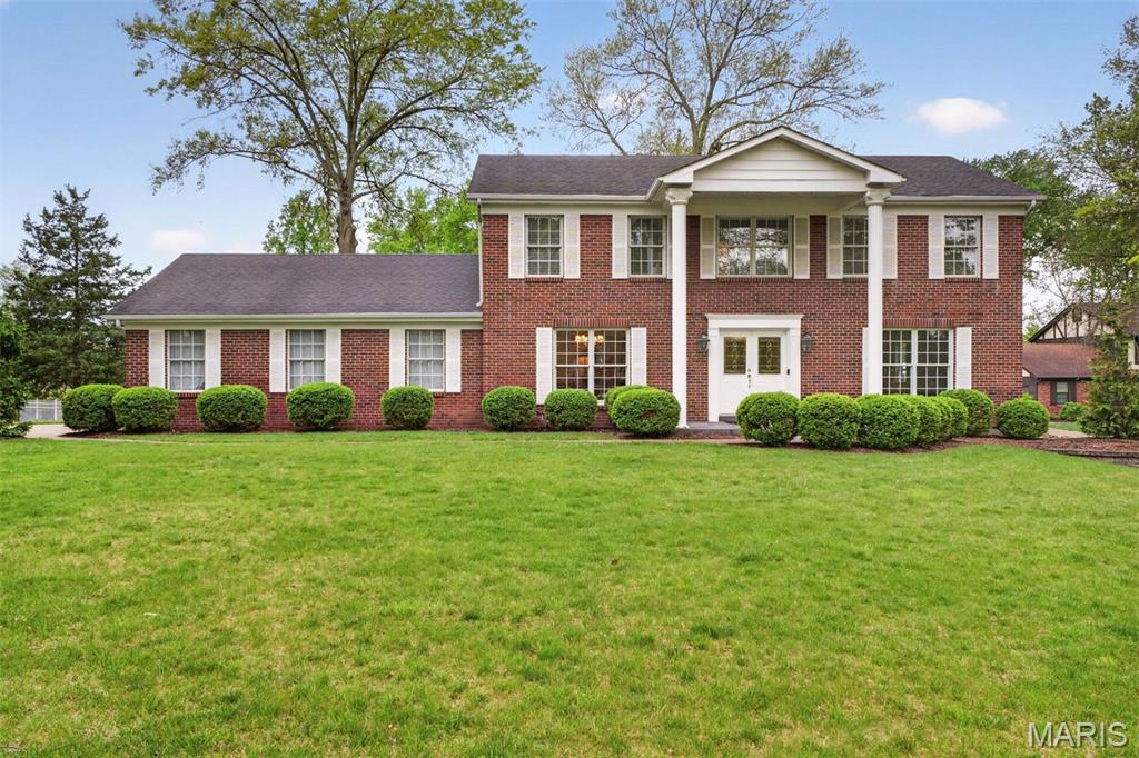 Welcome to Mason Valley! This classic center-hall, two-story brick-front home makes a memorable first impression with stately two-story columns and a prominent corner setting that sets it apart from surrounding homes. Inside, timeless design blends seamlessly with an open, connected layout. Just off the foyer, the den flows effortlessly into a spacious family room anchored by a wood-burning fireplace (gas starter), creating a warm and inviting gathering space. The rear of the home opens into a bright, airy floor plan centered around a beautifully appointed eat-in kitchen featuring stainless steel appliances, gas cooktop, double ovens, built-in refrigerator, center island, coffee bar, and abundant storage. A secondary prep sink and extended counter space offer the perfect setup for hosting, with easy access to the large dining room.
The main level is designed for both entertaining and everyday ease, with a convenient laundry room and drop zone just off the oversized three-car garage. Three sets of doors lead out to a large patio and a level backyard with plenty of green space, adjoining a quiet cul-de-sac for a sense of privacy and room to spread out. The expansive patio invites effortless outdoor living—ideal for weekend grilling, evening gatherings, or creating the outdoor kitchen you’ve always envisioned, with a gas line already in place to bring it to life.
Upstairs, the primary suite offers a spacious walk-in shower, dual vanity, and a generous walk-in closet. Four additional bedrooms and a full bath complete the upper level. The finished lower level adds even more living space with a large rec room, wet bar, and full bath, along with substantial storage space.
Mason Valley is known for its tree-lined streets, sidewalks, and active neighborhood feel, with year-round events, common ground, and tennis courts. Enjoy easy access to Queeny Park, the Town and Country trail system, and nearby coffee shops, ice cream spots, restaurants, and shopping—perfect for getting out and enjoying the area. Located near top-rated public and private schools, this home offers the ideal blend of classic architecture, thoughtful updates, and an unbeatable setting.

Additional features include an in-ground sprinkler system and electronic dog fence.