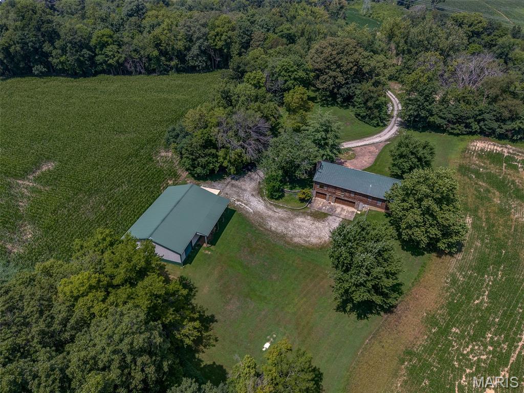 Online Auction – Sept 30 @ 10 AM. 128.88 +/- scenic acres just 15 min from the JB Bridge featuring a log cabin home, 40x60 metal outbuilding w/ concrete floor, electric & water. Approx. 89.36+/- tillable acres (open for 2026 season, subject to 2025 lease) & 39.52 +/- wooded/non-tillable acres—ideal for hunting, recreation, or potential lake sites. The 3-bed, 2-bath home offers vaulted ceilings, stone wood-burning fireplace, open kitchen/living space, main-level primary suite, & loft. Walk-out basement includes laundry, storage, & 3-car garage. Passed St. Clair County occupancy. Sold as-is. Unique opportunity to enjoy country living just minutes from St. Louis. Bid online! Advertised price is the the starting bid price. Subject to buyers premium and terms and conditions of auction.