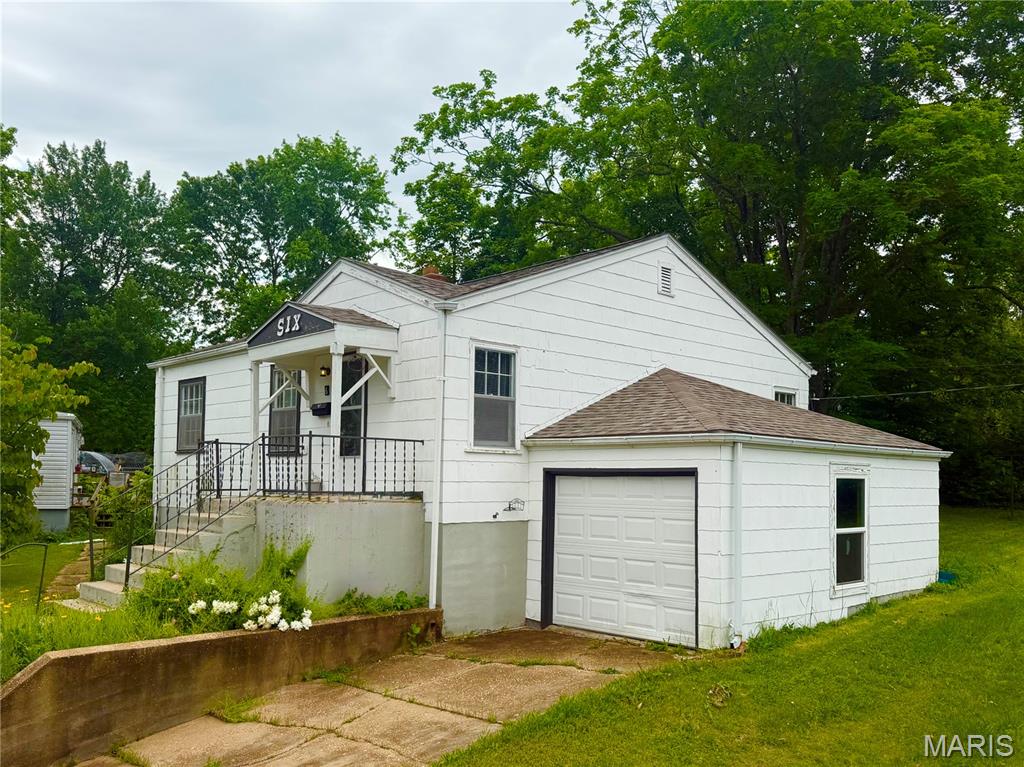 Priced below appraised value! Conveniently located on a cul-de-sac in the middle of Rolla, this adorable bungalow has tons of potential! The original oak floors have been beautifully refinished in the living room, hallway and both bedrooms. A fully equiped kitchen with electric range, dishwasher and refrigerator has an eat-in area and a side door to the back yard. The home has a new roof, newer HVAC and a single car attached garage. Beautiful flower beds with lots of perrenials give a warm "Welcome Home" every time you walk in the door! Call today for your private showing!