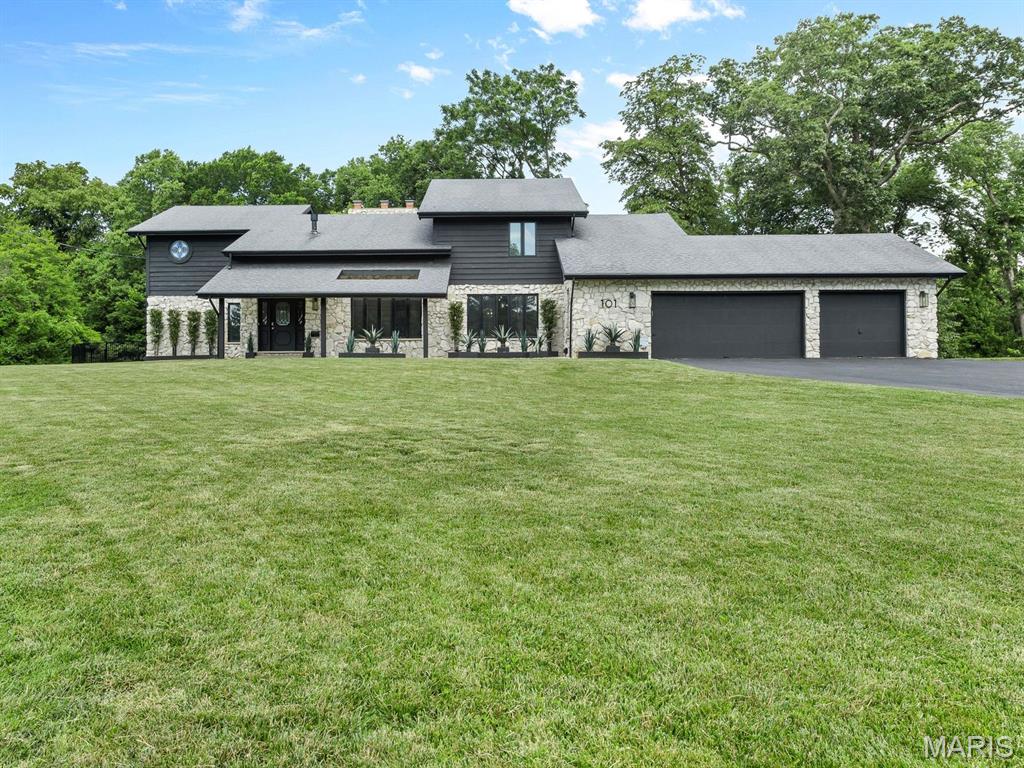 Beautifully renovated 5-bedroom, 4-bath architectural home offering nearly 5,000 sq. ft. of living space on a private, partially wooded ½-acre lot. Showcasing stunning natural stone, soaring ceilings, exposed beams, skylights, custom built-ins, a dramatic fireplace, brand-new flooring throughout, and abundant natural light, this home blends timeless craftsmanship with modern updates.  The gourmet kitchen features granite countertops and premium appliances, while a light-filled all-season room provides the perfect space for a home office, reading retreat, playroom, or year-round enjoyment of the surrounding landscape.  Designed for entertaining, the backyard oasis features a 20x40 inground pool with waterfall and diving board, private gazebo, fire pit area, and an expansive deck spanning the length of the home, all surrounded by mature trees and exceptional privacy.  The finished walkout lower level includes a wet bar, bedroom, full bath, flexible living space, and abundant storage. Additional highlights include a main-level bedroom, main-level laundry, and an oversized 3-car garage with workshop space.  Ideally located near top-rated schools, shopping, dining, and convenient access to downtown St. Louis and Lambert International Airport, this exceptional property offers the perfect blend of luxury, privacy, and everyday convenience.