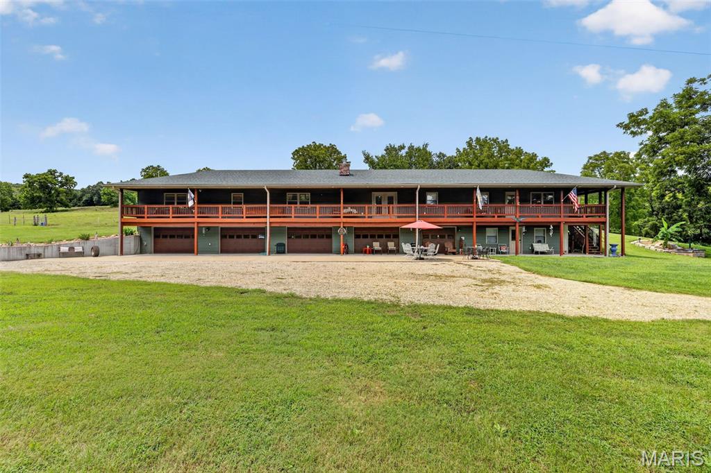 Welcome to a truly one-of-a-kind Central Missouri retreat, where luxury, privacy, recreation, and natural beauty converge across 222 acres of rolling hills, mature timber, approximately 40 acres of tillable ground, and a creek flowing alongside the property. Located along the Missouri River, Jefferson City is just 30 minutes away. Columbia and the Lake of the Ozarks are approximately an hour away, while St. Louis is only two hours away. With over a mile of road frontage, the possibilities are endless—whether you envision a thriving hunting retreat, private wilderness escape, homestead, new farm, or premier recreational lodge. The land offers potential for logging, abundant wildlife, and exceptional outdoor recreation. The proof is on the walls—wildlife in this area is truly unmatched.

At the heart of the property is an impressive 3-bedroom, 3-bath home designed to feel like an upscale country lodge while embracing seamless indoor/outdoor living. A cozy sunroom welcomes you into the kitchen and dining room. From there, a grand living room featuring a wood-burning fireplace and custom bar, creates the perfect setting for relaxing or entertaining after a day outdoors. The spacious primary suite offers a walk-in closet and luxurious resort-style bathroom, while custom woodwork and high-end finishes throughout give the home its distinctive, eclectic wilderness-lodge character.

Step outside onto the expansive covered deck stretching the full length of the home, an ideal place to take in the peaceful landscape, watch wildlife, or gather with family and friends. A large concrete patio at the front of the home provides additional outdoor living and entertaining space.

The lower level adds incredible versatility with an oversized 5-car garage and separate living quarters, offering ample room for vehicles, equipment, guests, or recreational gear. A shop and historic barn further enhance the property's functionality and character.

For year-round comfort and peace of mind, the home features geothermal heating and was thoughtfully built within the past six years, offering the quality, solid construction, and modern comforts of a newer home. Whether you're seeking a private sanctuary, a hunting and recreational destination, a working farm, or a legacy property to enjoy for generations, this extraordinary Central Missouri estate offers the land, improvements, wildlife, and setting to make it a reality. Properties of this size, character, and versatility are truly rare.

Listing Video and Photos-
https://listings.studio724photography.com/sites/ekpvaxog/unbranded
