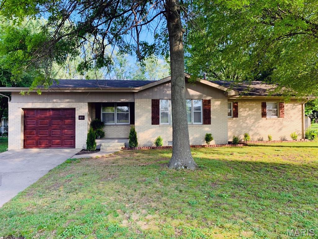 Beautifully updated 3 bedroom 2 bath home located directly across from Southwest Elementary in Dexter. This property features stunning wood flooring throughout, updated lighting, and custom architectural details including full-wall wainscoting. The living area includes a custom built-in electric fireplace that serves as a focal point for the space. The kitchen offers a gas range and gas hot water heater for efficient performance. Exterior features include a private deck, fenced backyard, fire pit and a one car garage. This home combines modern updates with classic craftsmanship and is move in ready.