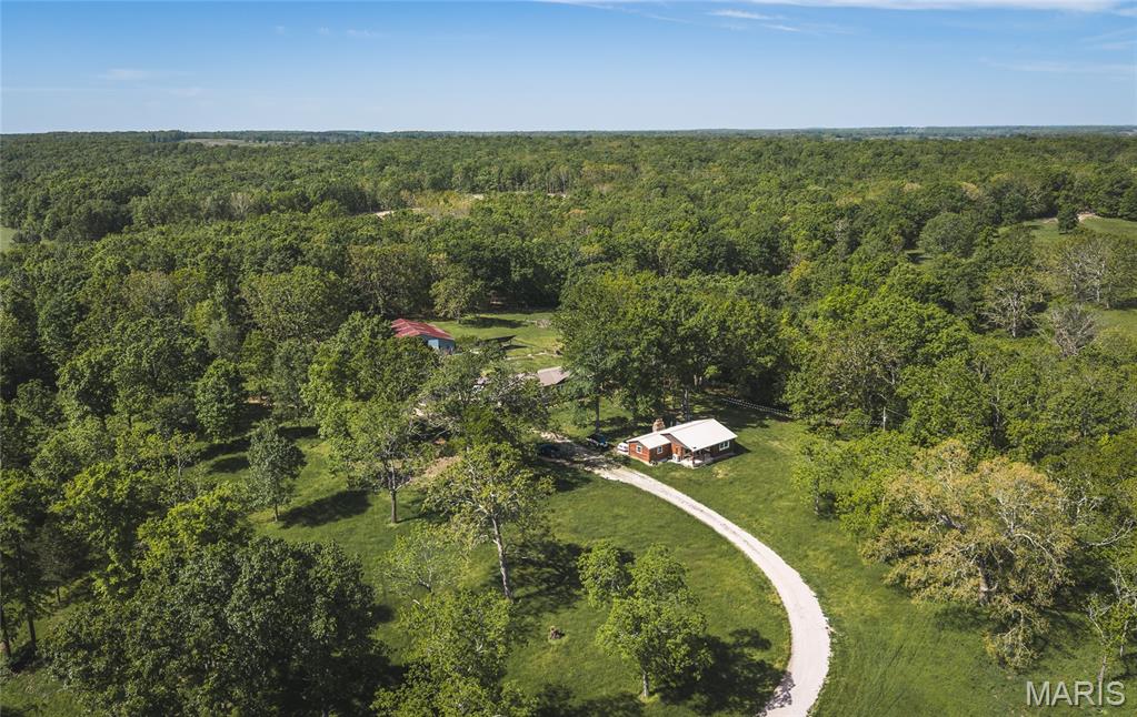 Opportunities like this don’t come around often—10 acres of usable land paired with not one, but two beautifully updated homes and an oversized barn, creating the perfect blend of flexibility, privacy, and potential. Whether you’re dreaming of multi-generational living, rental income, or a peaceful homestead with room to grow, this property delivers a lifestyle that’s hard to find.

The main residence, a brand-new 2025 manufactured home, offers modern comfort with a fresh, move-in-ready feel from the moment you step inside. Just a short distance away, the charming 2-bedroom, 1-bath log cabin has been completely gutted and thoughtfully remodeled, blending rustic character with updated finishes—ideal for guests, extended family, or even a short-term rental opportunity.

Step outside and take in the space around you. An established pecan orchard adds both beauty and seasonal bounty, while the oversized barn opens the door to hobbies, storage, livestock, or workshop needs. The acreage invites you to spread out, and with an RV hookup already in place, hosting guests or traveling with ease is effortless. With utilities connected to each structure, three separate septic systems, and the added benefit of solar panels, this property is set up for both convenience and efficiency.

If you’ve been searching for a property that offers versatility, income potential, and room to truly live your lifestyle, this is it. Schedule your private showing today and experience everything this one-of-a-kind property has to offer!