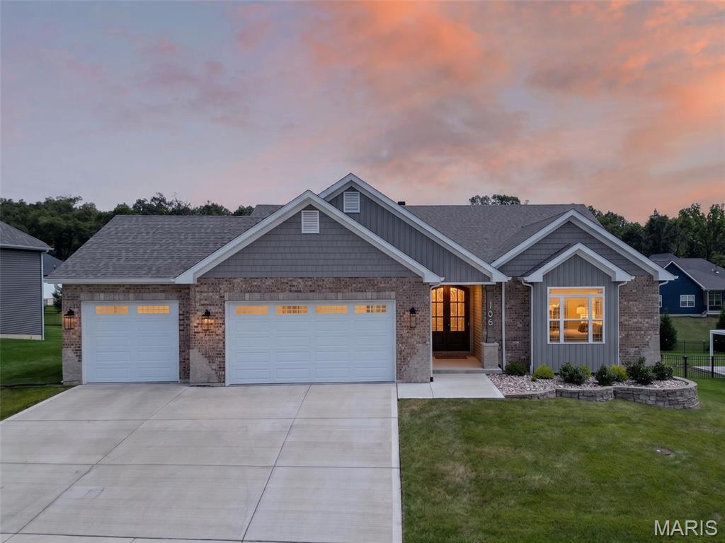 Welcome home to this stunning custom-built 3-year-old ranch with over $125,000 in premium upgrades! From the moment you step through the impressive double front doors with beveled glass, you'll appreciate the exceptional craftsmanship and attention to detail throughout.

The welcoming foyer opens to a spacious great room featuring soaring 11-foot ceilings, a beautiful marble wood-burning fireplace, and mantel that creates the perfect gathering space. The gourmet kitchen is designed for both everyday living and entertaining with 42-inch soft-close cabinetry, granite countertops, tile backsplash, stainless steel appliances, custom lighting, and an oversized center island with breakfast bar, built-in sink, and abundant storage.

The adjoining dining area opens to a maintenance-free covered deck, creating the perfect place to enjoy your morning coffee or unwind in the evening while overlooking the backyard and tree lines. Elegant 9-foot ceilings and crown molding flow throughout the kitchen, great room, and dining area. Durable laminate flooring extends through the main living areas and primary suite, while both bathrooms feature attractive tile flooring.

The spacious primary suite offers a tray ceiling, walk-in closet, and a luxurious en suite bath complete with double vanities, soaking tub, separate shower, and private water closet. A convenient main-floor laundry room includes a utility sink and built-in shelving.

The expansive walk-out lower level provides endless possibilities with a bathroom rough-in, and a sliding door opens to an 11' x 16' covered concrete patio—ready for your custom finishing touches.

Car enthusiasts and hobbyists will appreciate the oversized 35-foot-wide, 3-car garage featuring 8-foot-tall doors. The extra-deep third bay extends 27.5 feet with a 9-foot-wide door, providing ample room for a boat, oversized truck, workshop, or lawn equipment. Builders transferrable Limited Home warranty.

Situated on a beautifully landscaped 1/3+ acre lot with decorative retaining walls, mature shrubs, and tree line view for added privacy, this exceptional home is conveniently located near schools, shopping, dining, and offers quick access to Hwy. 70.

Luxury, quality, and thoughtful design come together in this exceptional home. Schedule your private showing today—this one won't disappoint!