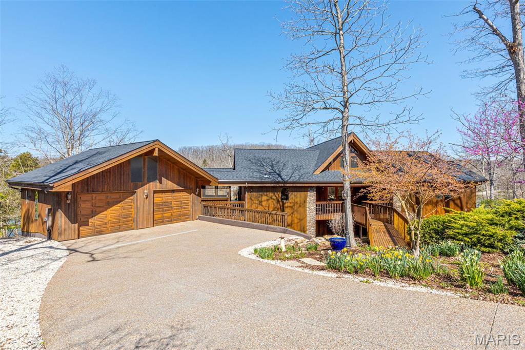 Nestled on coveted LAKE ALPINE, this stunning Lindal Cedar Home offers breathtaking views of three lakes and 364 ft. of LAKE ALPINE shoreline. And to add to the fun, this lakefront home comes with its own pontoon boat! Whether you're cruising into sunset dinners, fishing at dawn, or taking the kids around Alpine Lake on the weekend, your lake life starts the moment you get the keys. Spacious living, scenic views, and now your own boat? It's the total package. The mountain-style retreat features an expansive two-level wraparound deck with outdoor speakers and a serene water feature, including a stream, waterfall, and koi pond (all water features can be simplified for part-time ownership if desired). Inside, enjoy 4 bedrooms, 3 full baths, a loft perfect for a study or extra sleeping space, two laundry rooms, zoned HVAC, and 2 fireplaces. The fully finished lower level boasts surround sound, while soft-touch blackout shades (remote-controlled) add comfort throughout. Thoughtful upgrades include a brand-new roof (2025) and an updated in-ground irrigation system. Extra piering support was added at the time of build to ensure long-term stability. Cedar decks and outdoor lighting lead to the dock, making this a lakeside sanctuary.  Make new memories here, year-round or as a vacation getaway!