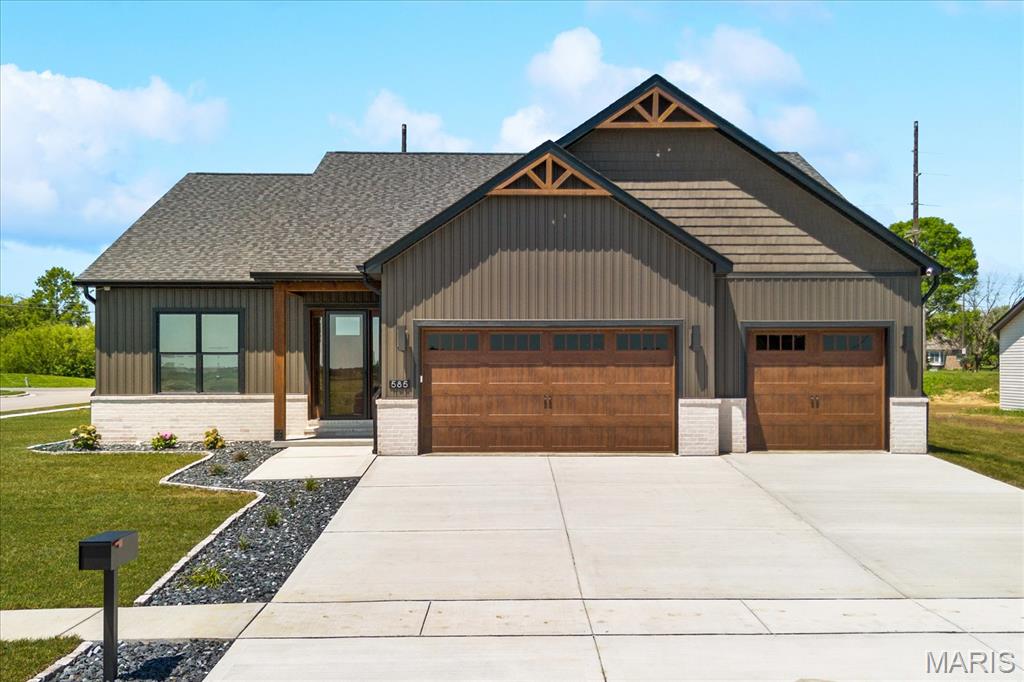 Introducing the FIR 2.0 by MJ Holland—an exceptional custom ranch designed to deliver luxury, functionality, and unmatched craftsmanship in the highly sought-after Augusta Greens community. Located within the award-winning O'Fallon School District, this stunning home offers over 3,600 square feet of perfectly designed living space and showcases the premium features buyers have come to expect from a Built by MJ Holland home. From the moment you enter, you'll be impressed by the soaring 10-foot ceilings, oversized 6-foot windows that flood the home with natural light, and elegant 8-foot interior doors. The open-concept main level is anchored by a spectacular vaulted great room and a designer kitchen featuring custom 42-inch cabinetry, quartz countertops, an oversized center island, and exceptional attention to detail throughout. The spacious split-bedroom floor plan includes three generously sized bedrooms on the main level, highlighted by a luxurious owner's retreat complete with dual walk-in closets, double vanities, a freestanding soaking tub, and a spa-inspired zero-entry tiled shower. The finished lower level is equally impressive, offering luxury vinyl plank flooring throughout, a massive recreation and entertainment area, a full bath, and two additional oversized bedrooms. One bedroom serves as a private junior suite with its own walk-in closet and en-suite bath—ideal for guests, multigenerational living, or a private retreat. Abundant unfinished space provides endless opportunities for storage, a home gym, workshop, or future expansion. Built with quality and efficiency in mind, this home features 2x6 exterior wall construction, a tankless water heater, and an oversized three-car garage with 8-foot garage doors to accommodate larger vehicles, boats, or recreational equipment. Combining luxury finishes, exceptional construction standards, and one of O'Fallon's premier locations, the FIR 2.0 represents a rare opportunity to own a truly distinctive custom home in Augusta Greens.