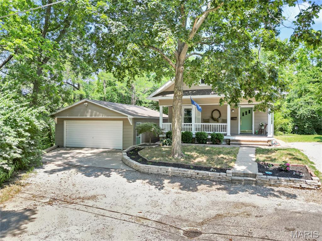 Tucked away at the end of a quiet cul-de-sac, this remarkable two-story home offers the perfect blend of charm, character, and modern updates. The beautifully landscaped exterior creates exceptional curb appeal, while the inviting covered front porch and private enclosed rear patio provide the perfect spaces to relax or entertain.

Step inside the tiled foyer and discover a thoughtfully designed interior featuring a unique blend of rustic charm and contemporary finishes. The spacious living area is anchored by a beautiful brick fireplace, while the dining room showcases a large picture window with built-in window seating and storage. The updated kitchen is a standout, offering stainless steel built-in appliances, a center island, and an oversized window overlooking the patio.

The main level includes two generously sized bedrooms and a large full bath. Upstairs, you'll find two additional bedrooms and a second full bath complete with a relaxing Jacuzzi tub. The full walk out basement offers endless possibilities for additional living space and currently includes a bonus room previously used as a bedroom, along with abundant storage.

This one of a kind home is filled with warmth, style, and opportunity you truly have to see it to appreciate everything it has to offer! Call your favorite agent today for a showing :)