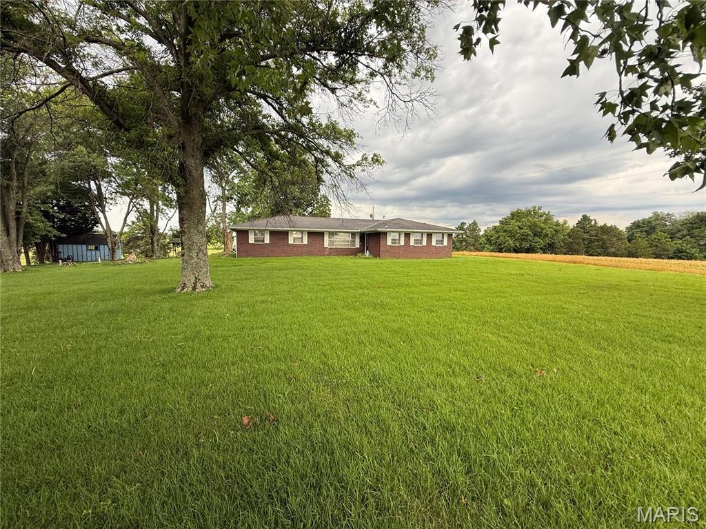 If you've been dreaming of country living, this 2 +/- acre property offers a peaceful setting with scenic views of the surrounding farmland. The 3-bedroom, 2-bath home features a full basement that is partially finished, an attached 2-car garage, and a covered back porch that's the perfect place to relax and enjoy the view. Several small sheds provide additional storage for equipment, tools, or hobbies. Final acreage to be determined by survey.

Additional acreage is also available for purchase, including adjoining 33 +/- and 76 +/- acre tracts. Buy the home on its own or expand your acreage to fit your needs.