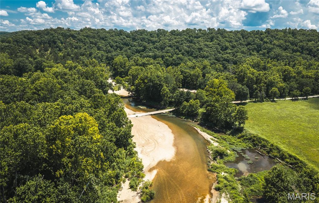 Discover a rare opportunity to own 9.7+/- acres in the heart of Camden County near Climax Springs, Missouri. Conveniently located just 30 minutes from Camdenton and 45 minutes from the Lake of the Ozarks, Spring on Little Niangua offers a beautiful building site with electricity already onsite, making it ideal for a dream home, cabin, or weekend retreat.

The property features approximately 0.25 miles of river frontage on the crystal-clear Little Niangua River, known for outstanding smallmouth bass fishing, floating, and year-round natural beauty. 

Adding to its uniqueness is a natural spring that produces approximately 50,000 gallons of fresh water per day. With no restrictions, you have the freedom to build, camp, hunt, fish, or simply enjoy the property however you choose.