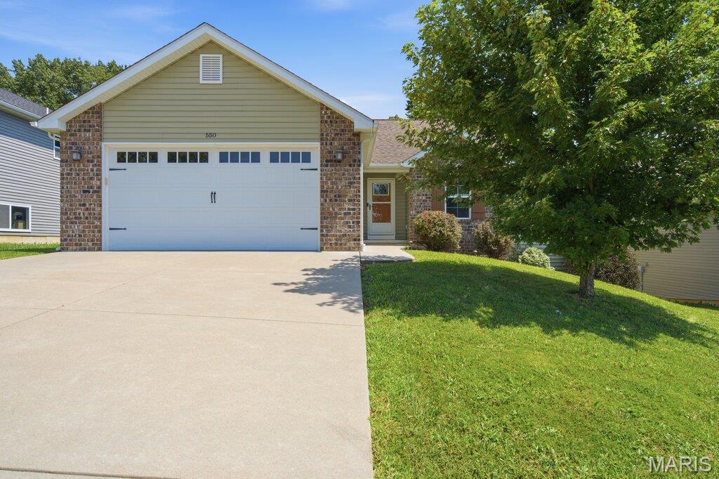NEW PRICE, WONDERFUL FLOOR PLAN & A BACKYARD YOU'LL LOVE! This well-cared-for home offers a comfortable layout, quality finishes, and thoughtful details throughout. Located in Walnut Ridge Place, with its beautiful subdivision lake, this home welcomes you both inside and out. The majority of the main level features gorgeous engineered hardwood flooring, while vaulted ceilings and attractive lighting adds to the home's bright and comfortable feel. The kitchen offers plenty of cabinet space w/crown molding, center island with breakfast bar, a soapstone double sink, backsplash, stainless steel appliances & pantry. The primary bedroom includes a walk-in closet,  full bath w/HEATED floors and secondary bedrooms are nicely sized w/ceiling fans. The backyard is sure to become a favorite gathering spot! Enjoy the beautiful pergola over the spacious patio, mature landscaping, and wood privacy fence. Whether you're hosting friends or enjoying a quiet morning coffee, there's plenty of room to enjoy the outdoors and a little R&R!  The partially finished walk-out basement adds even more living space, featuring a large rec/family area with charming barn doors, plenty of storage AND 4th bedroom & full bath ($40K addition). Modern updates, versatile living space and a terrific location come together to create a home that truly has it all! Act  now, you'll be glad you did!