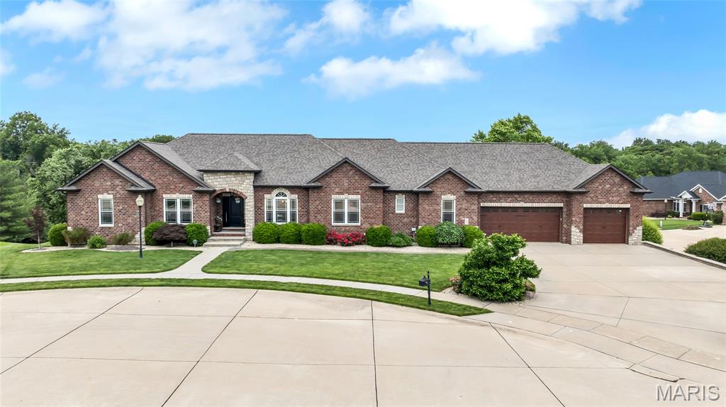 Welcome to your beautifully landscaped new home including a koi pond with mini waterfall and new composite bridge!  The front door opens to wooden flooring, tall ceilings and a corner stoned gas fireplace with a raised hearth, next to built-in book shelves and a TV that lowers from the ceiling in your living room (yours to keep)!   The eat-in kitchen has a large granite island and granite countertops.  It also boasts a steamer by the gas stove and double oven.  The second and third bedrooms both have their own private bathrooms.  The primary bedroom has a tray ceiling and the bathroom is resort like with a jetted tub and curbed walk in shower with decorative tile and pocket doors.  3 car oversized garage with bike rack and attic access with lights.  The back deck is 37'9" by 11'7" and has a covered section with cathedral roof and ceiling fan.  It overlooks the heated, in ground pool for more resort like features.  The walk out lower level has tons of storage and unique fireproof room, 10'4"x7'.