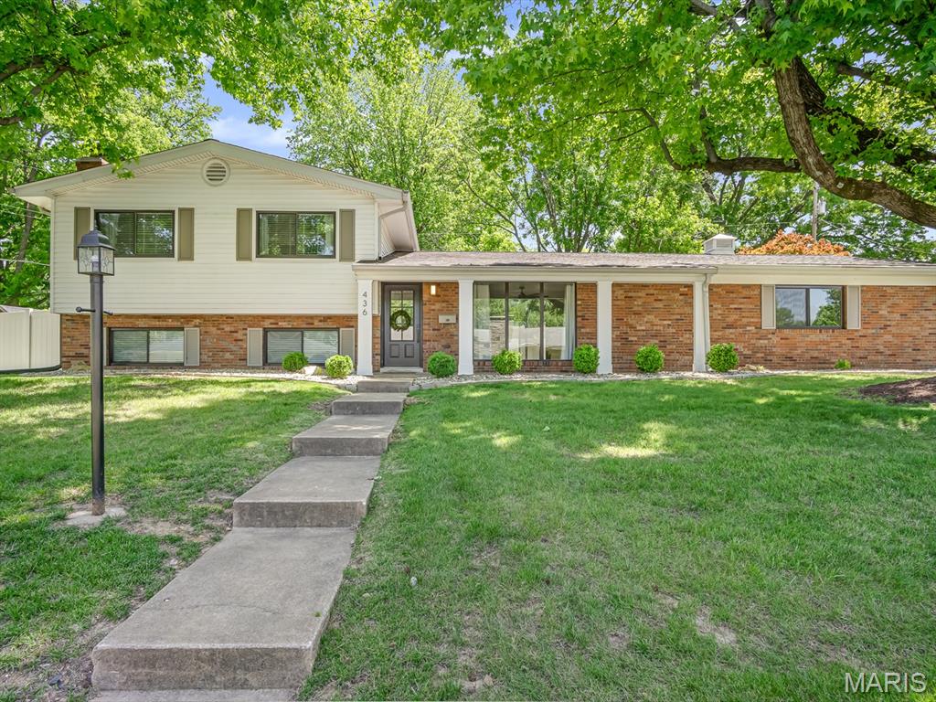 Updated throughout in beautiful Grandview subdivision, this fantastic trilevel is a must see.  With new windows, bathrooms, flooring, and chef inspired kitchen, you will be immediately impressed! Entry foyer with original wood detail adds instant character and leads into a wide open great room, kitchen w/island seating, and dining area. Kitchen features quartz countertops, tiled backsplash & 36" 6-burner gas range w/hood. Additional cabinetry was added to create organization and beverage center. The open concept floor plan flows from dining area to outside to entertain, relax, or play in spacious fenced yard. Bathrooms feature ceramic tile, new fixtures & custom made vanities! Upper level features primary with great natural light and ensuite bath. Two additional bedrooms and hall bath allow everyone the space they need. Lower level family room has w2 closets and charming fireplace. 4th bedroom in lower level is spacious. Laundry and half bath finish out the lower level! Oversized 2 car garage with EV charger plug in, large storage areas, new roof, new boiler system, new sewer line, new panel & updated electrical. Located in the quiet and quaint Grandview neighborhood, you are just a short distance to splash pad, dog park & downtown Edwardsville and everything GlenEd has to offer.  Schedule your private tour today.