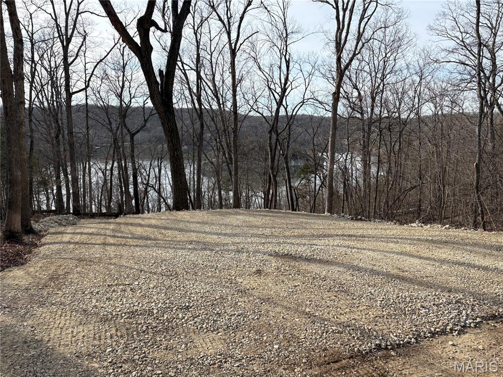 Stunning 0.47 Acre lakeview lot in Pinnacle Lake! This property comes complete with a level lot ready for you to park your camper, and a private entertaining area perfect to set a firepit overlooking the lake. Spend your summer exploring the 130-acre community lake that boasts excellent swimming, boating, and fishing. The view of Pinnacle Rock jutting out of the water is nothing short of awe inspiring. There are also miles of community roads to cruise your SXS and get to know the neighbors. Pinnacle Lake is a private, gated community less than an hour from Mid Rivers Mall. Making this a great alternative to some of the larger lake getaways.