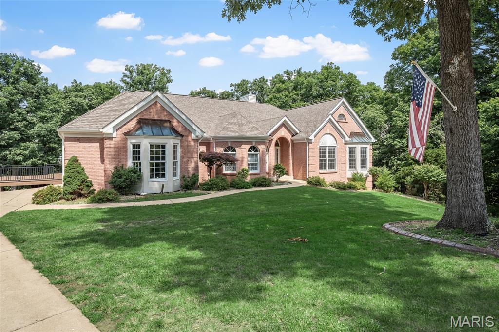Experience refined country living in the heart of Missouri wine country at this stunning custom-built brick atrium ranch in Defiance. Nestled on approximately 5 picturesque acres, this exceptional estate offers nearly 5,000 square feet of beautifully finished living space designed for both luxury and comfort.

Step inside and be captivated by the dramatic atrium wall of windows that floods the expansive great room with natural light while showcasing breathtaking views of the surrounding landscape. The spacious kitchen is thoughtfully designed with abundant counter workspace, tons of custom cabinets, and even a double oven, making it ideal for everyday living and entertaining alike.

The elegant primary suite is a private retreat featuring a coffered ceiling, a bay window, and a luxurious bathroom with separate vanities and a jetted soaking tub. There are four additional generously sized bedrooms that offer flexibility for family, guests, home offices, or hobby spaces.

The finished lower level provides exceptional living and storage options, including a Family Rm, Rec area, 2 bedrooms, and a bonus room with unlimited possibilities; two private storage areas and convenient access to the outdoors. Mature trees create a serene, park-like setting with privacy and natural beauty in every direction.

Car enthusiasts, hobbyists, and entrepreneurs will appreciate the oversized 3-car attached garage plus the impressive 25' x 40' detached 4-car garage/workshop—offering endless possibilities for vehicles, equipment, recreation, or a dream workspace.

This exquisite property combines sophisticated design, quality craftsmanship, and the tranquility of country living just minutes from award-winning wineries, scenic views, and all that Defiance has to offer. A rare opportunity to own an extraordinary estate where luxury meets lifestyle.

Open house Sunday 7/12, 1-3pm. Come and watch the deer play in the backyard.