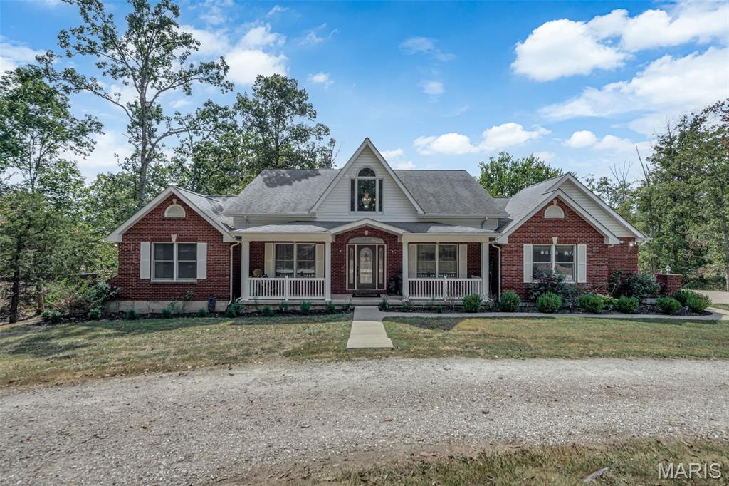 We have a kickout and our welcoming showings and other offers!! Beautiful 1.5 story home on 11+ acres with private pond. This home features 3 bedrooms, 3 full bathrooms and 2 half bathrooms with an attached 3-car oversize garage. You are welcomed with a nice large covered front porch that leads you into the entry foyer and living room boasting tons of natural light from the surrounding windows, gorgeous hard wood flooring throughout, high vaulted ceilings with an open stairway to the upper level. The eat-in kitchen is complete with beautiful custom wood cabinets, stainless steel appliances, farmhouse apron sink on the center island with a breakfast bar and a large walk-in pantry. Be sure to check out the cozy wood burning fireplace adding some extra charm to this country style kitchen. Master bedroom is on this main level with a large master bathroom including an oversize double vanity with tons of storage, walk-in shower and a garden tub. There is an additional room on this main level that could be used as a formal dining room or turned into an office/den. Completing the main level of this home is a convenient half bath and main floor laundry room. Upstairs you will find a nicely sized open loft area that looks out over the living room along with 2 jack & jill style bedrooms, connected full bath with large vanity and step-in shower. The walk-out basement has been partially finished with a large family room area with a beautiful brick wood burning fireplace. You will find a huge separate room perfect for a personal in home gym or office that boasts floor to ceiling windows with a clear view of the pond. Also on this level is a complete second eat-in kitchen with stainless steel appliances, tons of cabinet storage and counter space. Tons of convenient storage space completes this lower level. Onto the exterior you will enjoy the patio and large back deck overlooking the beautiful, stocked private pond that is perfect for relaxing on a nice day or entertaining guests. This home sits on a gorgeous corner lot surrounded with natural foliage and wildlife. Do not hesitate in making your appointment today to come see this beauty!