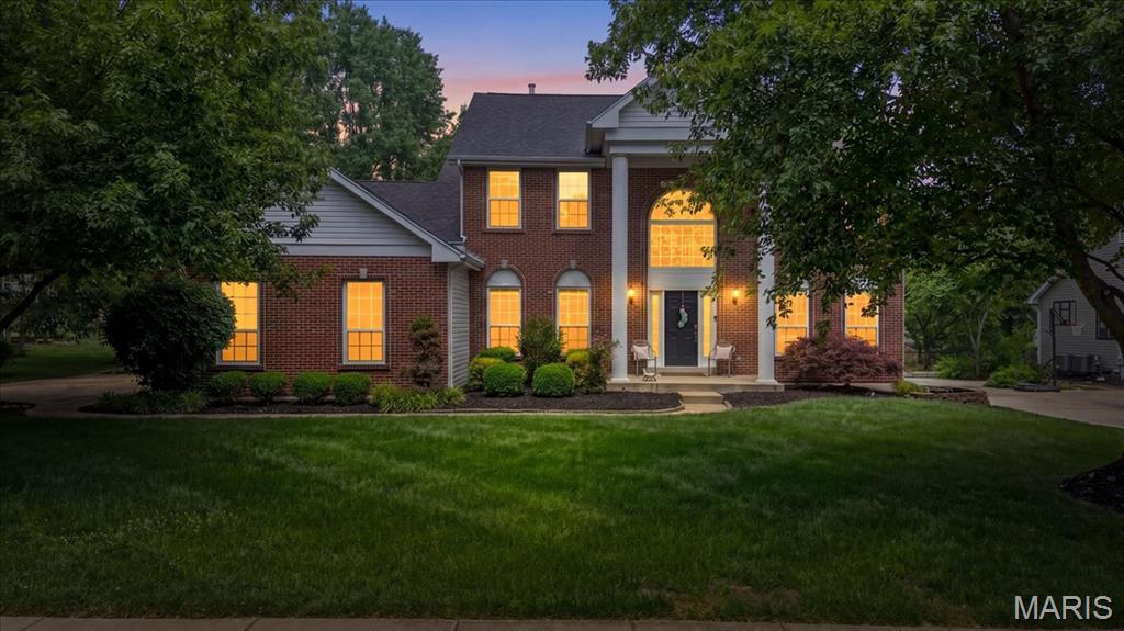 Stunning 2-Story brick home showcasing timeless elegance and over $150,000 in updates! A beautiful 2-Story entry with stately columns welcomes you into this meticulously maintained home featuring exquisite landscaping and a 3-car garage. The grand foyer opens to a spacious dining room and a gorgeous private study with French doors.  The impressive great room offers custom built-ins, a fireplace, bay window, an elegant T staircase with access to the upper level. The updated kitchen and breakfast room feature 42" white cabinetry, granite countertops, stainless steel appliances, and hardwood flooring that extends throughout the main level. Additional main floor highlights include a laundry room and powder bath. Upstairs, the expansive primary suite boasts vaulted ceilings, a walk-in closet with custom organizers, and a luxurious bath with dual vanities, soaking tub, and walk-in shower. Three additional bedrooms include one en suite and two connected by a Jack-and- Jill bath. The finished lower level provides abundant additional living and workspace along with a full bath. Outdoor living is exceptional with a large level lot, screened-in porch, and gorgeous patio perfect for relaxing or entertaining. This exceptional home combines elegance, comfort, and extensive updates in a truly beautiful setting.