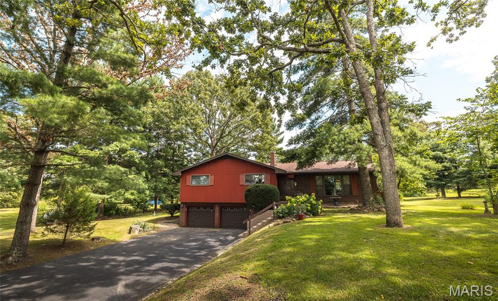 Don’t miss this rare opportunity to own a beautiful 6.1-acre property featuring a well-maintained 4 bed/2 bath home which offers 1,754 square feet of living space on the main floor. Enjoy the warmth of hardwood floors, tile, and carpet throughout, as well as a cozy wood-burning fireplace in the main living area. Basement includes 1051 sq feet,  a laundry room, large family/rec room, and a non-conforming bedroom or office (no closet).  Woods Basement System installed a sump pump in 2018 for added protection. Enjoy the outdoors with mature shade trees, and a deck out back to enjoy coffee, tea, the birds and other wildlife. It is the perfect spot for outdoor relaxation.  An asphalt drive leads to a spacious 2 car garage.  Also included is a second home (1,673 sq ft) on the property, currently uninhabitable due to water and mold damage—potential for teardown, rebuild, or renovation. Whether you're looking for a multi-family setup, rental income opportunity, or a peaceful retreat with room to grow, this property has all the right elements. Recreational opportunities are abundant with the Mark Twain National Forest located within a 5-minute drive as well as several creeks, hiking trails, fishing areas, campgrounds and also a golf course close by.  Schedule your viewing now!