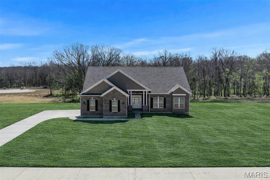 MOVE-IN READY NEW CONSTRUCTION — IRRIGATION INCLUDED AT NO ADDITIONAL COST! This is an exceptional opportunity to own a brand-new home on 3.05 acres in The Estates at Schaper Farms, with private well and septic already included in the purchase price, sod already installed, and a full irrigation system included at no additional cost as part of the builder's promotional package. Why wait to build when you can move right in and enjoy a complete new-construction acreage package without the construction wait or added expense of installing these systems yourself?

The Sycamore Model offers the ideal blend of space, quality, and setting on a beautiful walk-out lot in the highly sought-after Wentzville School District. This thoughtfully designed 3-bedroom, 2-bath ranch features 2,097 square feet of open-concept living with thoughtfully selected upgraded finishes throughout. The exterior showcases a striking brick and board-and-batten façade with an oversized side-entry 3-car garage measuring 30' x 24'.

Inside, you'll find 10-foot ceilings, 8-foot interior doors, and transom windows along the back of the home that fill the living spaces with natural light. The kitchen is designed for both function and style, featuring 42" staggered cabinetry, quartz countertops, a large island, walk-in pantry, soft-close cabinetry with dovetail drawers, and stainless steel appliances including a double oven, ceramic cooktop, cabinet hood, and microwave drawer. Luxury vinyl plank flooring extends throughout the main living areas, with ceramic tile in the bathrooms.

The private primary suite offers a comfortable retreat with dual vanities, a soaking tub, and walk-in shower. The walk-out lower level features a slider to the patio and provides excellent potential for future finished living space, allowing you to expand when you're ready.

Outside, enjoy your 3.05-acre homesite with sod already installed and a full irrigation system included at no additional cost. With the private well and septic already included in the purchase price, this home offers the convenience of a complete acreage package from day one.

The Estates at Schaper Farms also offers the added benefit of concrete streets — not gravel or asphalt — with plans for future city maintenance, providing a quality, finished streetscape and added long-term convenience for homeowners.

Move-in ready. Brand new. 3.05 acres. Private well and septic included. Sod installed. Irrigation included at no additional cost. Upgraded finishes. Concrete streets. No construction wait. Exceptional quality and a peaceful setting make this home stand out from the rest. Dare to compare. Open Houses are held every Saturday and Sunday from 11:00 AM–2:00 PM, with weekday tours available by appointment.