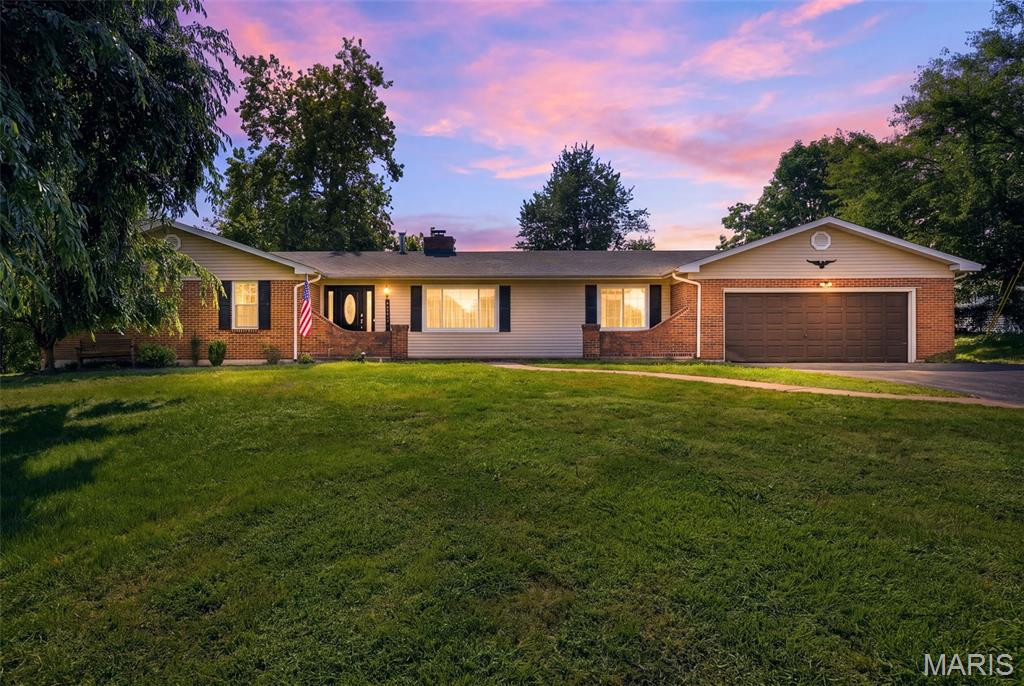 Welcome to this charming traditional ranch offering a lifestyle that’s hard to find in Maryland Heights! Nestled on a large, level and private .76-acre lot, there’s plenty of room for kids and/or pets to run and play, while the fenced yard and newer privacy fence create a peaceful outdoor retreat. Spend summer days enjoying the in-ground fiberglass pool, surrounded by generous patio space that includes a covered area perfect for relaxing or entertaining. Inside, this 4-bedroom, 2-bath home offers comfortable main-level living with new luxury vinyl plank flooring throughout most of the home. The kitchen features granite countertops, plenty of counter space and stainless steel appliances. The family room is filled with natural light from a beautiful bow window and features a striking brick wood-burning fireplace, creating a warm and inviting space to gather. The walk-out lower level offers additional space to spread out as well as storage. A 1-year-old roof and oversized 2-car garage add to the appeal.
The location offers the best of both convenience and community, with a neighborhood park nearby and the Maryland Heights Community Center, shopping and dining all close at hand. Rose Acres Elementary is just .4 miles away, and Pattonville High School is .6 miles away. A wonderful opportunity to enjoy privacy, space and outdoor fun while staying close to everything you need!