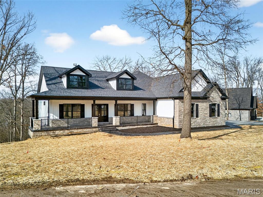 Looking for a new construction but don't want the wait? This newly completed home in the beautiful neighborhood, The Woods of Sandy Creek, is move-in READY! High-end finishes, a thoughtfully designed floor plan, and a finished basement! Beautiful stamped concrete bordered drive, porches, and walkways, double door front entry, vaulted ceilings, flexible office/ 4th main floor bedroom, waterfall kitchen counters, upgraded appliances, walk-in pantry, spacious primary bedroom, spa-like primary bathroom, HUGE primary closet/ laundry room combination (an absolute dream of convenience), luxury vinyl flooring throughout BOTH floors, custom tile work, the list goes on and on. The views from the back deck or bottom porch are peaceful and private. This home speaks for itself. It is an absolute DO NOT MISS.