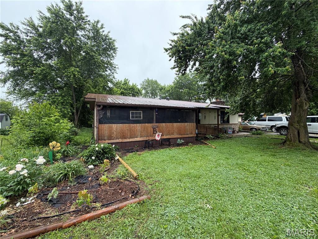 Located in Winona, MO on a Corner lot  with 3/4 Bedrooms, 2 Bath. Charming and spacious home located within walking distance of Winona Schools. This property features original hardwood floors in several rooms, a large family room or optional fourth bedroom, central AC and propane heat, and a fireplace for added comfort. The screened front porch with handicap ramp, back patio, and large fenced backyard offer great outdoor living spaces. Additional highlights include a metal roof, stainless steel side-by-side refrigerator, stove, large utility room with a cellar, and a beautifully landscaped front yard with mature flowers. Situated on a fenced in corner lot. Just ten minutes from Rocky Falls, a beautiful natural rock-based spring and local swimming hole, and only fifteen minutes from the scenic Jacks Fork and Current Rivers, this location offers endless opportunities for floating, hiking, horseback riding, and exploring the breathtaking landscapes that make the Ozarks so beloved. $129,900 Outbuildings do not convey with property.