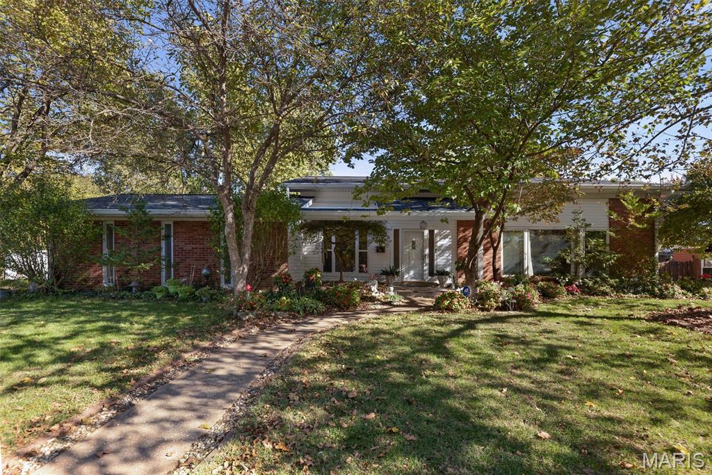 Spacious, tri-level home in Country Club Acres. boasts approx. 2920 square feet of living space is family and entertainment ready! The inviting front Porch leads into the huge Great Room/Dining Room with soaring ceilings. Nearby, updated, eat-in Kitchen has white cabinets and new quartz countertops. 3 Bedrooms upstairs: 1 with an in-suite bath-new shower, and 2 others that share a full bath. Just a few steps down leads to the spacious lower level including an entertainment-sized Family room with a fireplace. Walkout to the screened in Porch to take in the view of the beautiful, fenced (new) private backyard with mature trees. The primary Bedroom suite has a walk-in closet and an in-suite Bathroom with a walk-in shower and soaking tub. The massive Den/Office is equipped with a kitchenette, fireplace and beamed ceiling. A spacious laundry room and 1/2 bath finish off this level of the home. So many New items include: interior paint, some flooring, shower in in-suite bath,  roof, 6" gutters, drain tile, doors (ready to paint), windows (9 yrs.), fencing, hvac, garage door opener! Located conveniently to sought after Schools, churches, swim club, fitness club, shopping and medical facilities. Call to schedule your private viewing.