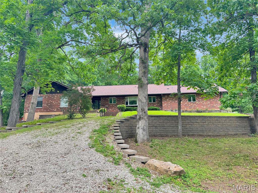 Secluded, sprawling BrickRanch with a circular driveway and over 3,300 sq ft of living space on the main level. Large Entry foyer that open to the Piano/Living room, stunning updated kitchen with under cabinet lighting, island, quartz countertops, stainless steel appliances, breakfast room, large rec room (red room), 2 fireplaces-living room & rec room, office area off breakfast room, formal dining area, and a large serving counter divider between breakfast room, dining room, 1/2 bath, and at the other end of the house is the primary suite, and 3 additional bedrooms with hall bath(tub/shower & double vanity).  In the basement/LL, you will find it to be unfinished with a large tuck-under 2-car garage that is extra deep. Laundry is in the LL. More potential here.  Driveway is shared, and cost shared. This quite oasis is awaiting you. Being SOLD as is. Come see!