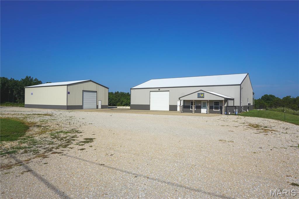 Exceptional commercial opportunity on 4 m/l acres just minutes from Rolla! Enjoy the convenience of being close to town while benefiting from the space, privacy, and functionality this property provides. The main 60' x 80' building features a climate-controlled shop with office, full bath with shower, heavy-duty concrete floors, three-phase power converter, dedicated paint bay with ventilation, concrete loading dock, and a covered concrete lean-to. A second 40' x 60' building offers a 16-foot overhead door, reinforced concrete flooring, and additional shop or storage space.

Approximately 2 acres m/l are leveled and graveled for equipment, trailers, or vehicle parking, providing ample room for day-to-day operations. Well suited for manufacturing, fabrication, contractor operations, trucking, warehouse/distribution, equipment sales, and many other commercial or industrial uses.

Need more room to grow? An additional 43.21 m/l adjoining acres are available for purchase, offering outstanding expansion, development, or investment potential.