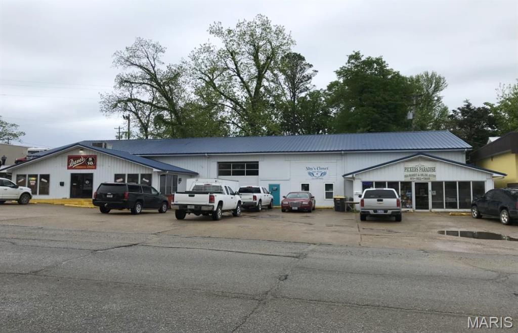Check out this multi-use large building in Downtown Doniphan! The possibilities are endless on this 6,800 + square foot commercial building! 
The building currently has a resale and flea market business on the west end of building and the other units are empty and ready for renters or for your business! This building is under $37/sq. ft. and priced to sell! The opportunities are endless!