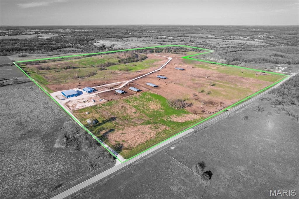 Turn-Key Cattle Feed Stockyard Operation - Excellent Investment opportunity with accelerated depreciation and increased cash flow potential.
Operationally ready for a Buyer, this intensive cattle feed site was clearly designed with a comfort and stress reduction purpose in mind to maximize weight gain.  The infrastructure of this ranch is exceptionally constructed with a feed alley central to the property supporting 12 production pens and lined with over 3,000 feet of feed bunks.  All pens are also lined with over 7,000 feet of custom welded pipe fence and gates along the alley with mostly 6-strand tight barbed wire cross-fencing.  Each pen is supplied by a freeze-proof waterer, while pens 1-5 are supported with red iron cattle shade structures with concrete pillar bases to protect the herd from rubbing injury.  Pens 1 & 2 are considered high density receiving traps with a 24” rock base to support large heard arrivals. The facilities are second to none and well-planned for maximum efficiency.  The receiving and loading dock is designed with an alleyway and working lane to safely load or unload cattle as they are directed to or from the sorting pens.  The 8,000 sq ft livestock barn houses an open-air covered working area with a platform scale, hydraulic squeeze chute, sick pen, connected sorting pens, and transition pen.  This facility also includes a climate-controlled office/storage area along with a bathroom.  Supporting the feed operation is the 8,000 sq ft Commodity Barn consisting of multiple bays, syrup tanks, and covered parking area for equipment along with an approximate 1/2 acre silage pad.  The buildings are all red iron structures less than 6 years old. Crafted with maximum efficiency in mind, this backgrounding facility optimally has supported 1,250 head at a time with capacity of up to 1,500.  But yet additional capacity expansion possibilities exist on the current acreage.  There is plenty of pen space allowing the herd to be rotated for grazing while feeding out nutrient-dense feed specially mixed on-site with the Roto-mix feed truck and syrup spray system while being transferred into the feed bunks.  
Finally, located at the entrance of the operation is a 1,100 sq ft ranch hand house for that ranch manager to keep a close eye on the operation.  The home (currently undergoing renovation), includes a dedicated well, electric utility, propane tank, and generator.  While the exterior has been completed and a new roof added, the interior has been stripped to the studs and is ready to be completely refinished.  Overall, this facility is a remarkable investment opportunity.