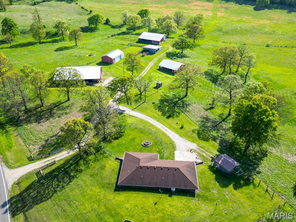 Gorgeous farm ground with an efficient 3-bedroom earth berm home and multiple outbuildings. This property has so many current features that make it ideal for a farming operation and homestead, whether you're looking to run cattle, horses, goats, or any other livestock you might have in mind. The land was previously utilized as a cow-calf operation and, in more recent years, has been used for hay production and sales. You can even store hay in one of the multiple buildings on site to keep it dry and sell throughout the winter.
A good portion of the property sits just above the average elevation of the county, making for beautiful views from the covered front porch of the home, and there are many whitetail deer and turkey that frequent the property. This property has great access to Hwy 17 and old Route 66 and is located within a 5-minute drive to Interstate 44 and within a 15-minute drive to the west gate of Fort Leonard Wood, MO, and local shopping. It is served by public water and electric on at least two sides.
There are a total of five exterior buildings that range in size, the first being 84'x40' with a full concrete floor and electric, plus a 10'x84' lean-to on either side. One of the other barns is 52'x72' with electric, along with a 36'x42' shop/barn with partial concrete and electric. There is also a 32'x50' barn with a dirt floor and a 36'x48' building with electric that was attached to the old cattle working facility plus an open sided building most recently used as a chicken house.
The home has been well maintained and is efficient, featuring three bedrooms and a nice open-style floor plan with a vaulted ceiling and wood beams in the living room and kitchen. The covered front porch gives way to a beautiful view of the yard and most of the property. From the time you pull into the driveway, it feels like you are entering a serene, private getaway with views of mature oak trees, yet you're still close to local amenities. A property like this, with so many features, a great location, and a lot of infrastructure already in place, doesn’t come along often. Come and see all this property has to offer.