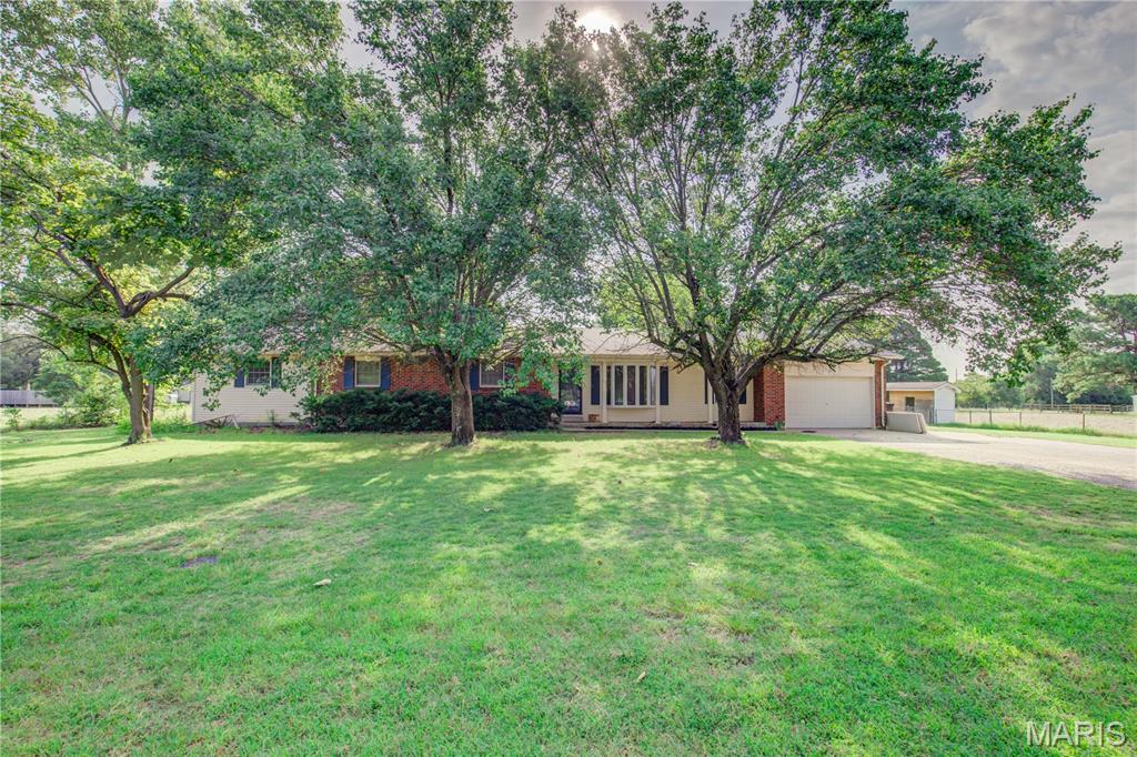 Welcome home to one of the area's most sought-after subdivisions, just outside the city limits! This spacious 4-bedroom, 3-bath home offers the perfect blend of comfort, functionality, and room to roam on 1.84 beautifully fenced acres.

Step inside to an inviting living room filled with natural light from the skylight and anchored by a cozy fireplace, creating the perfect gathering space. The home features updated flooring throughout much of the interior, along with all new kitchen appliances, making it move-in ready from day one. Enjoy the added savings and energy efficiency of the installed solar panels.

A rare basement—hard to find in this neighborhood—provides endless possibilities for a recreation room, home gym, storm shelter, additional storage, or extra living space. Outside, you'll appreciate the privacy and space that 1.84 fenced acres provide, all while enjoying the convenience of being just outside the city limits in one of the area's most desirable subdivisions.

This home truly checks all the boxes with its location, acreage, updates, and unique features. Don't miss your opportunity to make it yours!