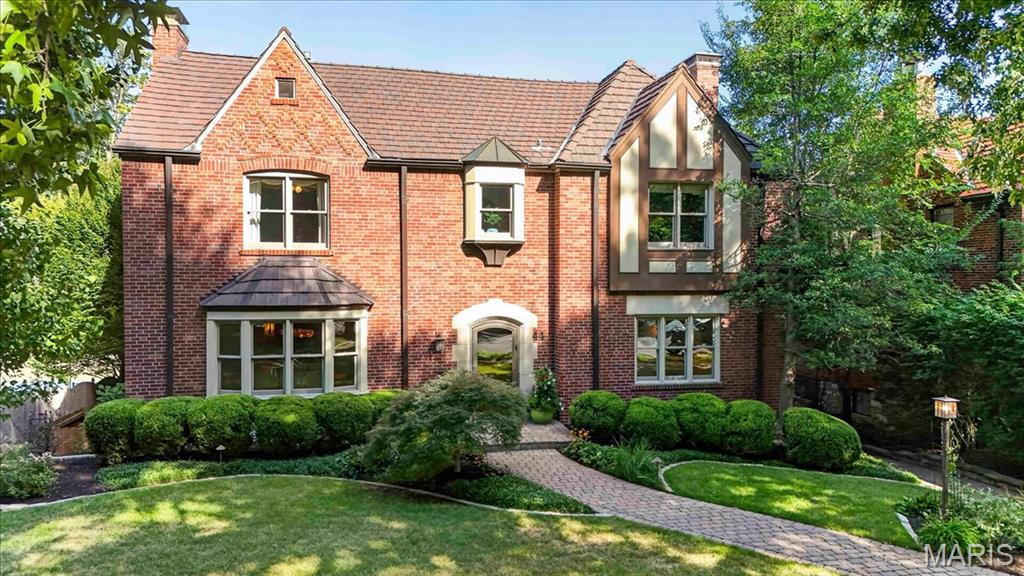 Set on a private, beautifully landscaped lot along mature, tree-lined Broadview in coveted Claverach Park, this exceptional full-brick residence embodies the enduring appeal of a home built with permanence in mind. A clay tile roof, classic center-hall floor plan, gracious proportions and light-filled gathering spaces create a timeless backdrop for elevated, move-in-ready living.  A marble-tiled entry welcomes you inside, where high ceilings and beautiful hardwood floors establish an immediate sense of refinement. At the center of the home, the open cook’s kitchen features custom cabinetry, high-end appliances, a walk-in pantry and a fabulous bar with a full-size wine refrigerator. From here, the home unfolds naturally into extraordinary spaces designed for both intimate evenings and effortless entertaining.  Upstairs, the expansive primary wing offers a private retreat, complete with a spa-like bath featuring a walk-in shower and Jacuzzi tub, two walk-in closets and a private gym. Four additional bedrooms, two beautifully updated full baths and a full laundry room complete the second floor.  The finished lower level extends the home’s living and entertaining space with another exceptional gathering area and a full bath. An expansive, upgraded three-car garage provides three full-size bays along with abundant additional storage.  The outdoor spaces are equally compelling. Manicured landscaping, mature gardens and picturesque walkways surround the residence, while a covered walkout terrace leads to a beautiful patio with a built-in brick fireplace, ideally shaded by a magnificent magnolia tree. There is ample room for a future pool, and the expansive driveway serves as the neighborhood basketball court.
Beyond the property, Claverach Park offers a lifestyle defined by connection and convenience: children riding bikes, welcoming neighborhood gatherings, sidewalks, nearby parks and restaurants, and award-winning Clayton Schools.  Updated, move-in ready and beautifully presented, this is more than a home—it is a rare opportunity to experience the Claverach Park lifestyle at its very best!