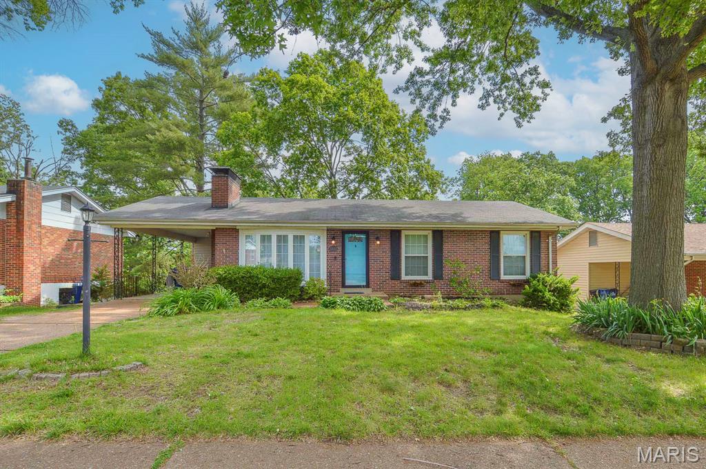 Beautifully maintained and truly move in ready, this solid brick 3BR/3BA ranch in the sought after Yorkshire Estates neighborhood offers timeless charm paired with thoughtful modern updates. Set on a generous 0.28± acre lot with mature shade trees, the home also includes an attached single car carport. Located in the Lindbergh School District and close to major thoroughfares, this property delivers both comfort and accessibility. Step inside to a sun filled living room where large bay windows illuminate rich hardwood floors and floor to ceiling brick surrounds the wood burning fireplace, an inviting space for relaxing or entertaining. The adjacent kitchen and dining area make daily living effortless, featuring new stainless-steel appliances and stone countertops installed in 2025. A floor to ceiling picture window frames sweeping views of the expansive backyard, creating a warm and welcoming dining experience. Two spacious bedrooms share a recently updated full bath by Bath Fitters (2025), while the larger primary suite offers ample closet space and a private half bath. The partially finished walk out basement significantly expands your living space. A large rec room with a bar opens to a brick patio through sliding glass doors. A three quarter bath and bonus room provide flexibility for a potential fourth bedroom, home office, or hobby room. Additional unfinished space offers abundant storage and houses the laundry area. With its recent updates, versatile layout, walk out lower level, mature landscaping, and prime location, this home presents an exceptional opportunity for buyers seeking a move in ready property with enduring appeal. Sellers are electing to sell as-is.