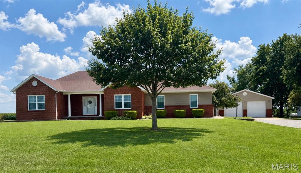 Custom-built home on a spacious one-acre lot just outside the city limits. The main level features a welcoming living room with a fireplace, formal dining room, and a large kitchen with abundant cabinetry and workspace. The primary bedroom includes a generous walk-in closet, and the primary bath offers a dual-sink vanity, jacuzzi tub, and separate shower. Two additional bedrooms and a hall bath provide comfortable main-level living. A well-appointed laundry room includes a counter, sink, and extra storage.  The lower level expands your options with a media room, second kitchen with a bar and refrigerator, full bath, and an office with another large walk-in closet. Outdoor living is enhanced by a fenced backyard and deck, perfect for relaxing or entertaining. Parking and storage are exceptional with a two-car attached garage plus a two-car detached garage. A whole-house generator adds peace of mind. This property offers space, functionality, and a desirable location close to major routes, shopping, and community amenities. Buyer to verify all information

-