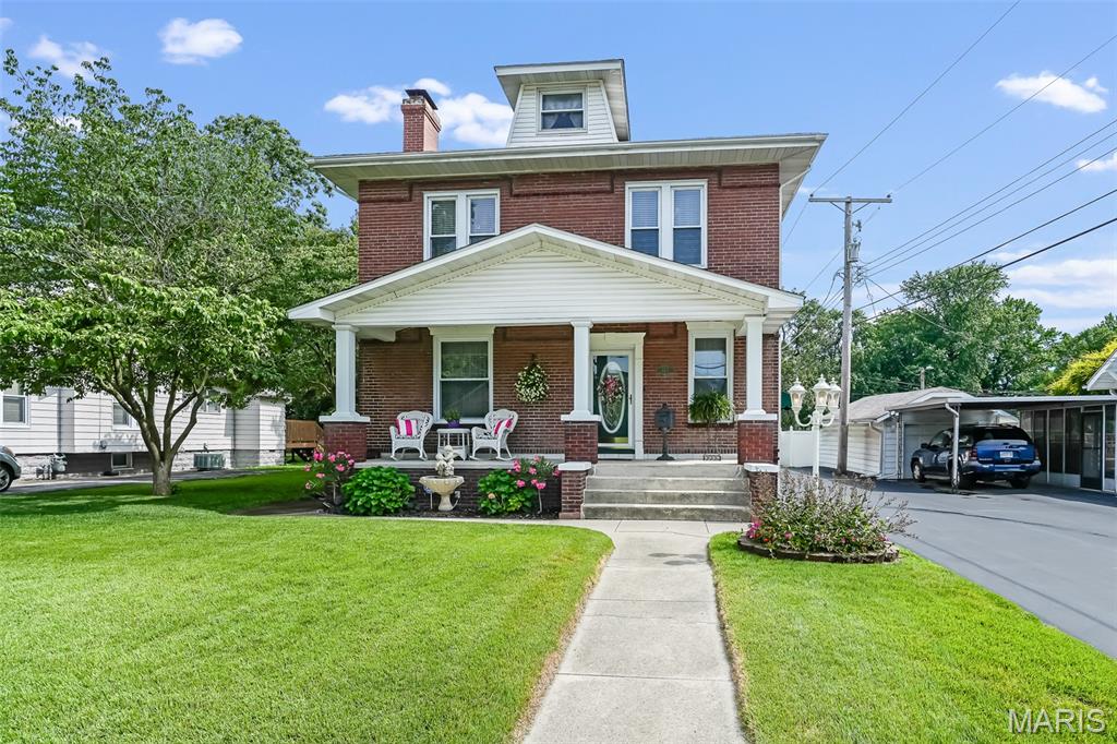 This historic 4 bedroom/3 bath home in Wood River is quite nostalgic and timeless with the craftmanship of a gone by era displayed throughout plus all the modern conveniences you want today.  Beautiful entry/foyer with marble flooring has an inviting feel that welcomes family and friends. You will immediately see the original woodwork, special order window coverings and drapes with sheer elegance.  To the left you will find the living room with fireplace and mantel (was updated to gas) on matching marble to the foyer. The living room connects to the dining room combining for the perfect open space to relax or entertain. The kitchen has been thoughtfully updated with spacious cabinets, granite countertops, under cabinet lighting and modern appliances which are included. The large master bedroom has a gorgeous and unique combination chandelier/ceiling fan (Fandelier) which really adds elegance to the room.  The master bathroom has its own private jacuzzi tub with fountain, standalone shower, vanity with make-up area, walk-in and linen closets. Upstairs the 3 oversized bedrooms keep their original character with unique decor, that make this home special.  There is a bonus room (currently used as dressing room) attached to the first bedroom.  It could also be used as a nursery, office, walk-in closet, sitting room or playroom, etc.  The 2nd floor bath has a large vanity and tub/shower combo. The basement is fully finished with a family room including a small bar, an office, and combination laundry room/kids playroom. Plenty of storage as well. The basement was waterproofed with a transferable warranty by  Helitech.  The covered front porch offers a perfect setting for relaxing, while overlooking mature dogwood trees, and fountain surrounded by flowers.  The backyard is an oasis for tranquility with concrete patio, large fenced in beautifully landscaped yard, mature trees and lilac bushes.  Or fire up that grill and invite family and friends.   This home has received a Wood River appearance award and was featured as one of the Most prestigious historical homes in Wood River during a tour in 2008. This home is unique and also served as a Tea Room in the 1920’s.   You will really need to see this one in person to fully appreciate it.  It’s located in a great neighborhood and is close to shopping, schools, parks, and interstates. Call today for your personal tour.