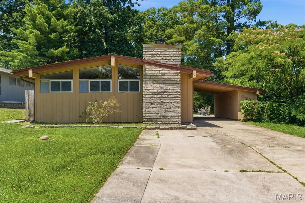 Welcome to 1029 Coffey Court in the highly desirable Ridgewood neighborhood of Crestwood. Designed by renowned St. Louis architect Ralph Fournier and developed by visionary builder Burton Duenke, Ridgewood is recognized as one of the region's most significant collections of Mid-Century Modern homes, celebrated for its timeless design, functional layouts, and connection to outdoor living. Built in 1953, this classic one-story ranch offers an opportunity to own a piece of architectural history while adding your own personal style and updates. The home features three bedrooms, one full bath, and a functional floor plan designed for comfortable everyday living. The non original G-shaped kitchen includes a peninsula that provides additional workspace. Large windows invite natural light throughout the home, highlighting the clean lines and simple elegance that define Mid-Century Modern design. Outside, the level backyard offers space for entertaining, gardening, or creating your own outdoor retreat. An attached carport, dedicated laundry room/mechanical area, and patio add convenience and practicality to the property. Being sold as-is, where-is, this home presents a rare opportunity for buyers seeking to preserve and enhance an authentic Ridgewood residence. Whether you're a Mid-Century Modern enthusiast, an investor, or a homeowner with a vision, this property provides the perfect canvas for your improvements and personal touches. Conveniently located near parks, shopping, dining, Grant's Trail, and within the award-winning Lindbergh School District. 1029 Coffey Court combines architectural pedigree, a sought-after location, and exceptional potential. Bring your imagination and make this well taken care of Ridgewood classic your own.
