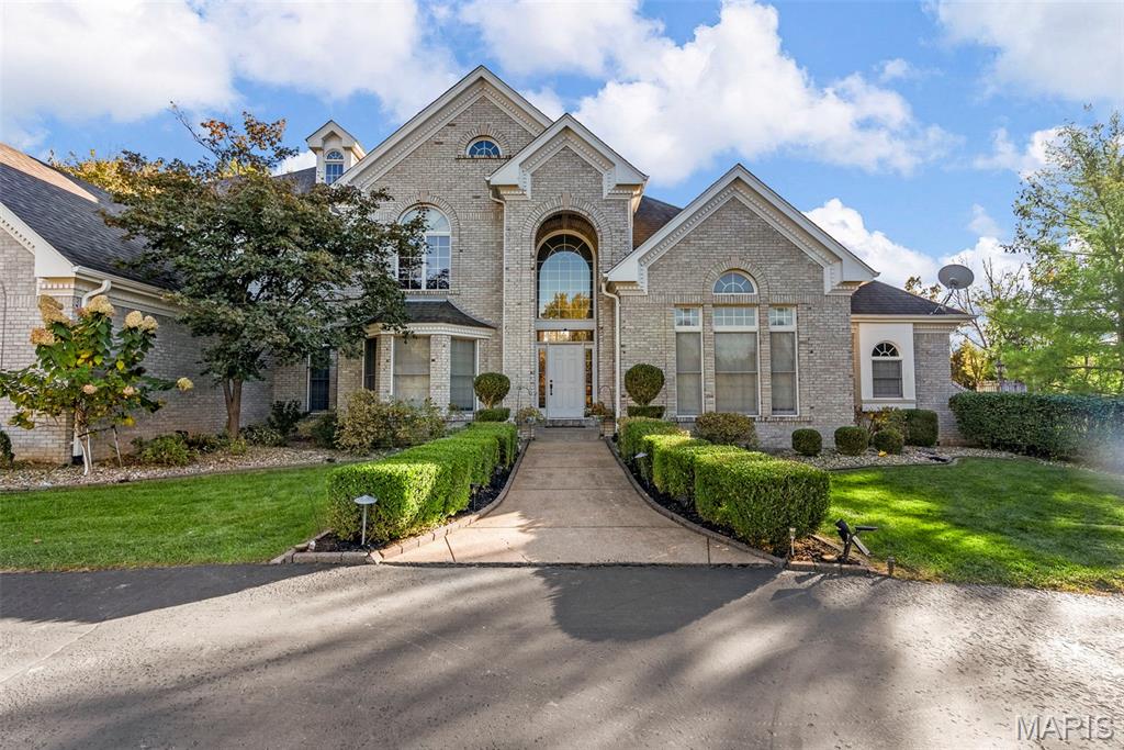 Rare equity opportunity in Town and Country. Priced nearly $100/sq ft below neighborhood average to allow for your custom kitchen and bath dream-renovation on this private acre lot. See supplements for design renderings!! Discover the epitome of refined living in this magnificent estate located in a small enclave of luxury homes in the exclusive Topping Ridge Estates Subdivision. Get close to 7,000 sq ft of living space and an acre lot for under $2M in Town and Country. Nestled within the prestigious Parkway West School District, this home seamlessly blends classic architectural details with high-end finishes to create a sanctuary that is both grand and deeply inviting. The breathtaking double story foyer features striking black marble flooring and introduces you to a pristine canvas ready for your personal style. Enjoy a dedicated home office with arched windows and a sophisticated dining room featuring soft blue hues and a classic crystal chandelier. In the center of the house is a show-stopping great room defined by a towering wall of windows that floods the home with natural light, a stately fireplace, and a soaring vaulted ceiling. The heart of the home features crisp white cabinetry, premium appliances, and a sleek black center island with breakfast bar seating—perfect for morning coffee or evening entertaining. The hearth room has vaulted ceilings, a second fireplace, and tons of natural light. On the other side of the house, find the main floor primary suite. It is a true getaway, offering a spacious bedroom with a tray ceiling and private sitting area. The spa-like ensuite bathroom has a double vanity, HUGE walk-in shower, tons of storage and two customized walk-in closets. The 2nd floor extends the living quarters with a large rec space that could be a living room, play room, or office! 3 additional spacious bedrooms, 1 with ensuite bath, & 2 connected by a Jack n' Jill bath complete the upper level. More than just a basement, this completely finished walkout serves as a secondary living quarters or the ultimate entertainment hub and makes this house perfect for multi-generational living! A full sized second kitchen comes with full sized appliances and a center island. Multiple good sized open areas for a home gym, theater, or playroom. Additional full bathroom, right off of the private bedroom with two customized walk-in closets and attached office or flex space. Situated on an extensively landscaped one acre lot with an oversized three car garage and large deck overlooking the woods for the utmost privacy.