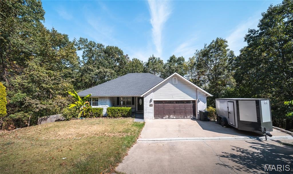 Welcome home to this beautiful 4-bedroom, 3-bath ranch over a finished basement, perfectly situated in a quiet, desirable neighborhood. With a spacious layout, inviting outdoor spaces, and plenty of room to gather or unwind, this home was designed for comfortable everyday living. Step inside to an open floor plan highlighted by vaulted ceilings that create a bright, airy feel throughout the main living area. The kitchen flows seamlessly into the dining and living spaces and features stainless steel appliances, making it easy to stay connected whether you're preparing dinner or entertaining guests. The main level offers three bedrooms, including a relaxing primary suite complete with a private bath and tiled walk-in shower. Step outside onto the covered back deck, where peaceful views of the woods provide the perfect backdrop for morning coffee, evening meals, or simply enjoying a little quiet at the end of the day. Downstairs, the finished lower level expands your living space with a huge family room ready for movie nights, game days, a home gym, or entertaining. A fourth bedroom and additional full bathroom make this level ideal for overnight guests, older children, or a private home office setup. Outside, the low-maintenance fenced backyard offers a manageable space for pets, play, or relaxing without spending your weekends on extensive yardwork. With its versatile floor plan, wooded backdrop, and sought-after neighborhood setting, this home has so much to offer. Schedule your private showing today and come see why this could be the perfect place to call home!