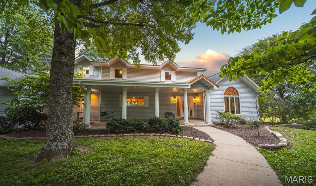 Surrounded by mature trees and tucked away just five miles outside of Rolla, this beautifully updated custom home offers the kind of privacy and space that’s genuinely hard to come by. Set on 24.5 acres of rolling Missouri hills — with roughly half fenced pasture, half hardwood timber, and a peaceful creek along the northwest corner — this is a rare opportunity to own a true estate property.

From the moment you arrive via the paved circular driveway, the quality and care poured into this home are unmistakable. Recent renovations have touched virtually every corner — new plumbing, electrical, paint, carpet, light fixtures, and bathroom fixtures — all while preserving the custom character that makes this home exceptional. Solid wood doors, rich hardwood and tile floors, soaring vaulted ceilings, and intricate custom woodwork set the tone throughout.

The main level impresses with an open floor plan anchored by a striking central floating staircase. The chef’s kitchen features a large center island perfect for gathering, while the expansive living room floods with natural light beneath vaulted ceilings. Thoughtful architectural details carry through every room. Step out from the main level onto the deck and down the stairs to the pool and patio area below — a natural flow for entertaining from inside to out.

The primary suite is a world unto itself — fully reimagined with a dedicated media room, a spa-caliber bathroom with soaking tub, oversized tile shower, and a private deck for a breath of fresh air without ever leaving your retreat. A massive walk-in closet with mirrored built-in shelving and dedicated in-closet laundry keeps life convenient without missing a beat. And for the book lover or the dreamer, a hidden library with floor-to-ceiling custom built-in bookshelves awaits behind a secret door.
The walk-out lower level is just as impressive. Beautifully finished with 9-foot tray ceilings, the basement bedrooms each feature their own walk-in closets — offering guests or family members a retreat that feels anything but basement-level. Step outside directly to the in-ground pool and patio, where the surrounding trees and natural beauty of the property create a setting that’s hard to leave.

A metal outbuilding provides ample storage for equipment, livestock needs, or hobby space. The land is fully fenced and ready for horses or cattle, with a creek, timber, and rolling terrain that make every acre a pleasure to explore.

Properties like this don’t come around often — and they don’t last long.
Agent owned and lovingly maintained — now offered due to out-of-state relocation.