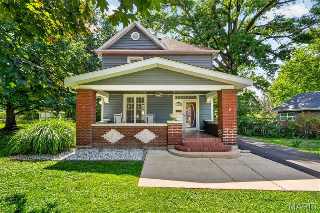 Looking for a spacious 3 bedroom home on almost 1/2 acre and a garage?  Look no further.  You'll love the curb appeal from the moment you pull up with the large brick covered front porch and updated siding and windows.  Step inside and notice the built in shelves on both sides of the fireplace, stain glass windows and crown molding.  Beautiful original pocket door opens up to the large dining room.  There is a bonus room off the dining room perfect for a reading area, home office or playroom.  The updated kitchen offers fresh paint, new flooring, large walk in pantry, pretty cabinetry and stainless steel appliances. The number of windows allow an abundance of natural light to flow in throughout the entire home.   Upstairs includes the bedrooms and full bathroom.  You'll love hosting summer bbq's with the covered back porch on a double lot that is level and fenced.  You'll appreciate the new roof, gutters/downspouts, window wraps, fenced yard, 25x20 garage and shed pad.  Sellers are also providing a Guard Home Warranty for your peace of mind!