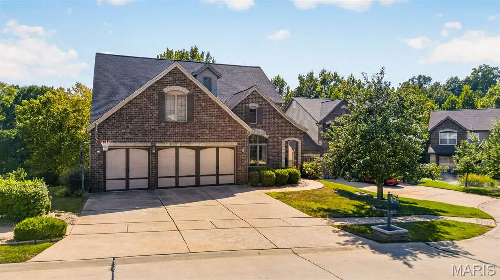 Built in 2007 and designed for effortless living and entertaining, 5450 Hagemann Pointe Drive offers more than 4,300 square feet of finished living space with an open and versatile floor plan and an unexpected resort-style backyard.

A soaring two-story entry washes the interior in natural light, where hardwood floors, expansive windows and open spaces create an easy flow between the home's gathering spaces. At its heart, the kitchen features custom cabinetry, granite countertops, a center island, breakfast bar, walk-in pantry and adjoining breakfast room, all opening to an elevated deck overlooking the pool and wooded backdrop. The dramatic two-story living room is anchored by a gas fireplace and offers tree-line vistas.

The main-floor primary suite provides a private respite with a spa-inspired bath with dual vanities, jetted tub, separate shower and walk-in closet. A main floor mud/laundry room connects the ktichen with the three-car garage, offering modern convenience. Upstairs, three additional bedrooms and a flexible loft provide generous accommodations for family, guests, work or play.

The lower level opens to the ultimate in entertaining zones. Designed as a destination of its own, it includes spacious media and game rooms, surround sound, a second full kitchen with island seating, full bathroom and direct access to the outdoor entertaining areas—creating an ideal setting for movie nights, game days, pool parties and overnight guests.

Outside, the home transitions into a private retreat. An in-ground swimming pool, covered lounge, expansive patios and handsome stone fireplace create multiple spaces for entertaining, dining and relaxing beneath a canopy of mature trees.

From pool days and movie nights to the everyday convenience of walking to Hagemann Elementary, this is a home designed for your room to grow!