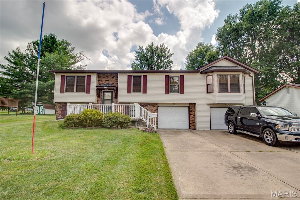 Welcome to this well-maintained Jerseyville home offering plenty of living space inside and out! Featuring an inviting entryway, an open living and dining area with durable luxury vinyl plank flooring, and an updated kitchen complete with a breakfast bar. Just off the kitchen, the enclosed sunroom with warm wood flooring provides the perfect spot to relax while overlooking the fenced backyard, with easy access to the deck for outdoor entertaining.

The spacious family room boasts a vaulted ceiling, creating a bright and comfortable gathering space. Three main-level bedrooms and a full bath provide convenient everyday living.

The finished lower level expands the home's versatility with a large fourth bedroom featuring a walk-in closet, a dedicated office, a 3/4 bath, and a laundry room, making it ideal for guests, working from home, or additional living space.

Outside, you'll appreciate the concrete driveway, attached two-car garage with two separate overhead doors, built-in storage on one side, and a workshop area on the other. The vinyl exterior with brick accents, fenced backyard, and deck complete this move-in-ready Jerseyville home.