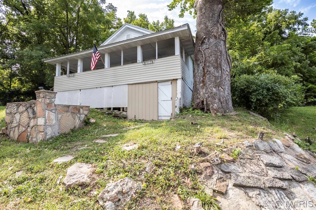 Perched overlooking downtown Waynesville, this charming 3-bedroom, 1-bath bungalow is full of character and timeless appeal. Inside, you'll find an open floor plan that creates a bright, welcoming living space, while outside you'll enjoy a quaint outdoor entertaining area and a classic front porch that's perfect for morning coffee or relaxing in the evening. Conveniently located just minutes from shopping, dining, and everything downtown has to offer, this bungalow blends charm, comfort, and convenience.