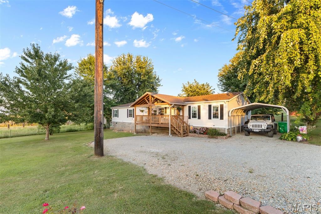 Private 20 acre m/l retreat minutes from town! This 3 bedroom 2 bath home offers the perfect blend of privacy, space, and convenience. Nestled on approx 20 acres, the property features mostly open pasture with scattered trees and  several barns providing plenty of room to enjoy the outdoors, animals, recreation or simply the peace and quiet of country living. Relax on the covered porch and take in the serene surroundings. Inside , you'll find a large living room and a spacious kitchen with lots of cabinets and storage and main floor laundry. Enjoy the best of both worlds-peaceful, private acreage while still being just minutes from town!