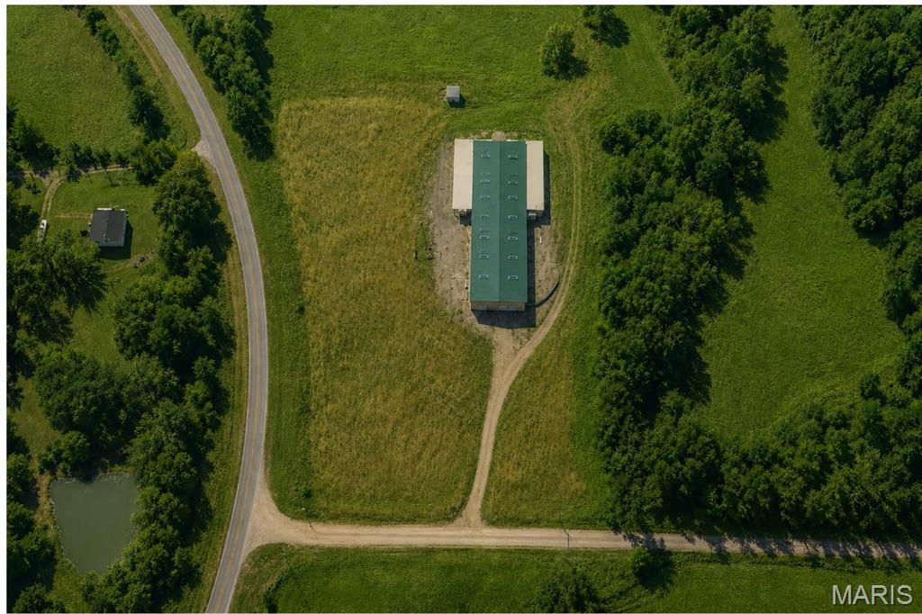 Why would you want to buy a warehouse in the middle of nowhere?
Because the middle of nowhere is actually the middle of everything.

Located in a highly centralized area, this property sits within 30 minutes of both sides of the Lake of the Ozarks, under 30 minutes to Fort Leonard Wood, and less than 30 minutes to Lebanon, making it an ideal hub for businesses that need space, access, and flexibility without the congestion and cost of larger commercial centers.

This expansive warehouse offers over 10,000 square feet of usable space situated on 5 acres just outside of Richland, Missouri, with excellent visibility and access.

The building features 14-foot drive-through garage doors on both ends, along with two additional attached sections, each equipped with their own garage doors—ideal for equipment storage, logistics, light industrial work, or business operations.

Inside, the property is equipped with propane radiant heating, three-phase power, and a full security system, supporting a wide range of commercial or industrial uses.

Infrastructure is already in place with a private well, private lagoon septic system, and approximately 480 feet of Highway A frontage, providing easy ingress and egress for trucks, trailers, or customer traffic.

The interior also includes multiple additional rooms that can serve as offices, workspaces, or can be removed entirely to create even more open warehouse space, depending on your needs.

Whether you are looking for large-scale storage, a headquarters for your business, a logistics hub, or a facility with room to grow, this property offers the space and functionality to support it.

Opportunities like this don’t come along often.
Schedule your private tour today and be sure to check out the drone property tour.