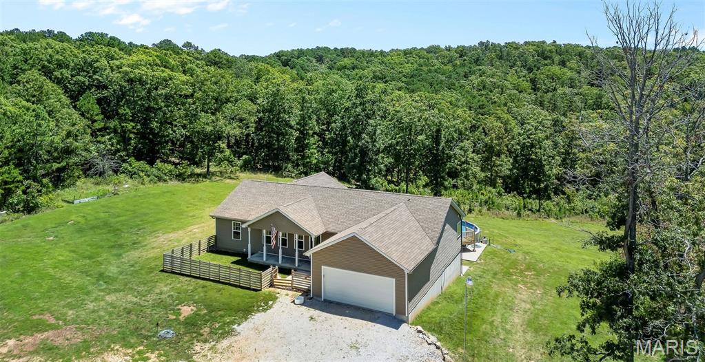 LAST PRICE ADJUSTMENT!
The tractor, camper, and zero-turn mower stay with the property, making this an even better opportunity to own your own private retreat.
Don’t miss your chance to tour this custom-built 4-bedroom, 3-full bath ranch home situated on 14.29 picturesque acres. Designed with an open-concept layout, the home offers a spacious vaulted Great Room that seamlessly combines the kitchen with breakfast bar, dining room and living room areas. Don't forget it includes a 2-car attached garage, and a fully finished walkout basement featuring a wet bar, pool table, and home gym — perfect for entertaining or relaxing at home. Primary bedroom boasts a full bath with jetted tub and separate shower, walk in closet and gorgeous view. Rustic finishes add to the country charm this property exudes and you will love!
Step outside and enjoy the above-ground pool and concrete patio, ideal for summer gatherings and peaceful country living. Additional upgrades include a dual-zoned HVAC system and a constant water pressure system for enhanced comfort and efficiency.
As an added bonus, the property also includes a charming 1,100 sq. ft. log cabin complete with 1 bedroom and 1 full bath — ideal for guests, extended family, or potential rental income.
Schedule your private showing today and experience everything this unique property has to offer!