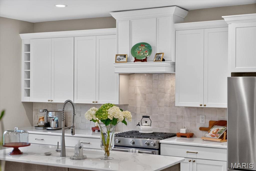Better than new and designed with intention, this two-year-old Fischer & Frichtel home stands apart with elevated finishes, custom details, and a prime setting in Cottleville Trails (Five houses down from path that thates you directly to downtown Cottleville). An upgraded stone exterior creates a striking first impression, while inside, custom millwork, designer lighting, and a bright, open floor plan give the home a polished yet inviting feel. At the heart of the home, the kitchen pairs quartz countertops with upgraded KitchenAid appliances, a five-burner gas range, custom wood range hood, stylish backsplash, elevated fixtures and hardware, a large pantry, and adjoining breakfast area. The open layout flows effortlessly into the living space, creating a home that works just as well for entertaining as it does for everyday life. Upstairs, three generously sized bedrooms are filled with natural light and thoughtful details, including custom wainscoting. The spacious primary suite feels like a true retreat with an oversized walk-in closet and private bath featuring a soaking tub and separate walk-in shower. Downstairs, an egress window and bathroom rough-in offer excellent potential for additional finished living space while still providing abundant storage. The lifestyle is just as appealing. Cottleville Trails offers walking trails, lakes, sidewalks, and a community pool, all within easy reach of Frankie Martin’s Garden and the restaurants, shops, and entertainment of Downtown Cottleville. Clean, current, and exceptionally well cared for, this is the rare opportunity to get the feel of a thoughtfully designed new home without the wait, added expense, or endless decisions of building one yourself.
