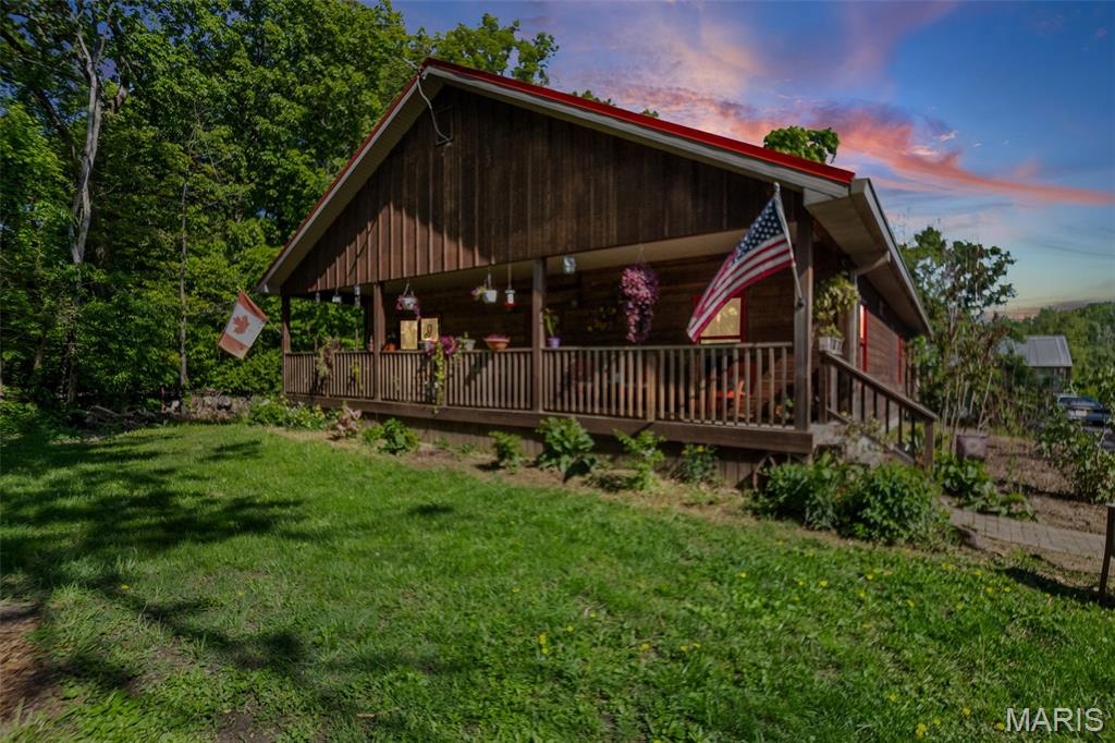 Country Living at its Finest! Custom built (2014) ranch on 4.29 acres offering the perfect mix of modern living and homestead potential! Features 100 x 200 fenced garden, established orchard (peach, pear, plum, apple, hazelnut) grapes, gooseberries, blackberries. 10 x 20 greenhouse plus a grow room. Wooded acreage attracts abundant wildlife! Main level offers over 2,600 sq ft including, 3 bedrooms, 2 full baths, a 19 x 23 summer kitchen ideal for canning, baking and entertaining. Kitchen is a chef's dream and features a Bluestar cooktop, double wall oven, copper countertops, oversized fridge and ample storage. Spacious primary suite with rustic full bath (clawfoot tub and shower) and a large walk-in closet. Living room with wood burning stove, 2 additional bedrooms, a full bath, and laundry room/pantry complete the main level. Partially finished basement with large bedroom and walk in closet, unfinished full bath (fixtures included) plus plenty of storage.  In addition to the attached 2 car garage, you'll also find a 40 x 64 shed/shop for all of your hobbies! This is a one-of-a-kind property perfect for those wanting a hobby farm or just seeking rural living minutes from town! Don't miss this chance to own this incredible slice of countryside!!